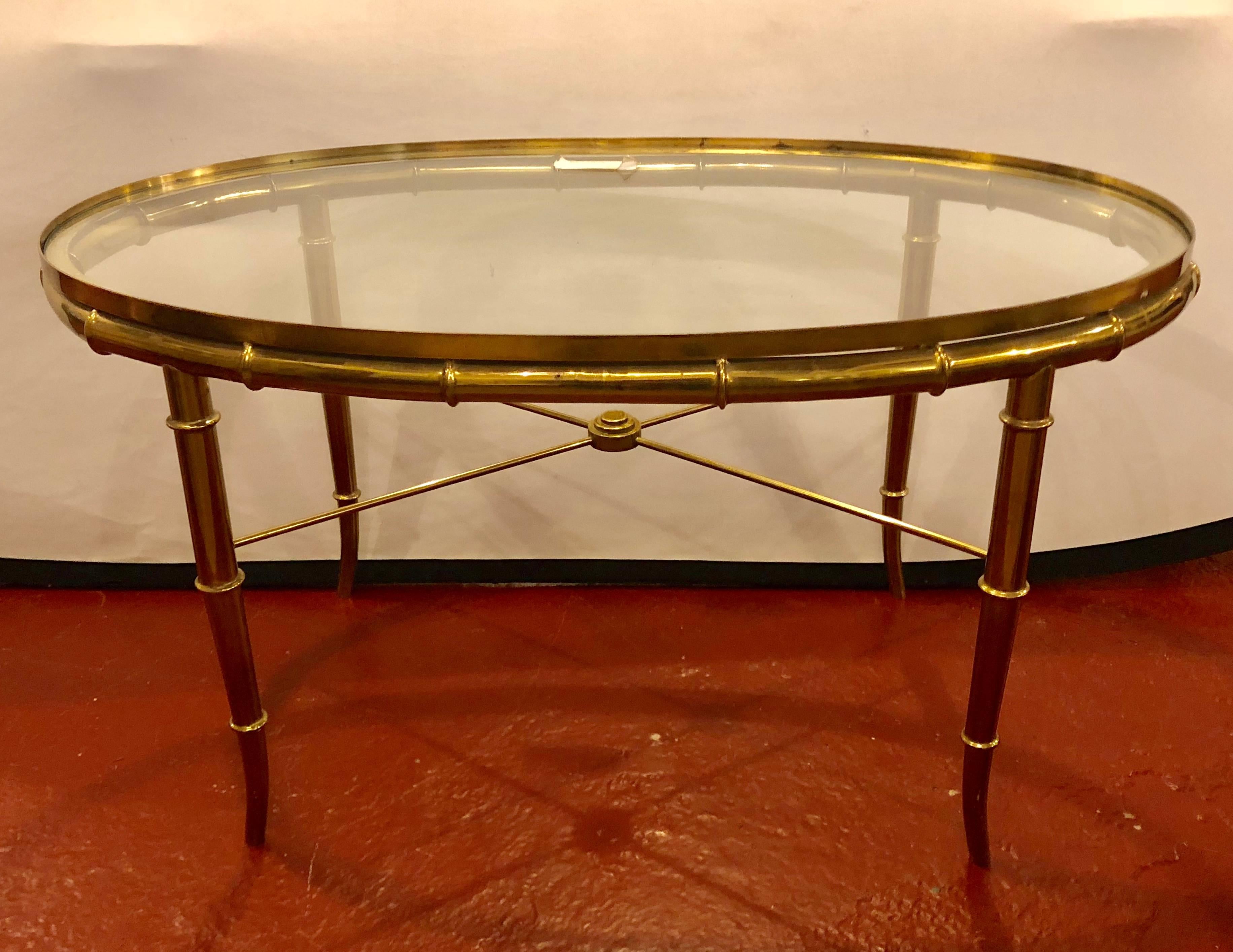 A Hollywood Regency style gilt metal faux bamboo oval glass top coffee table.