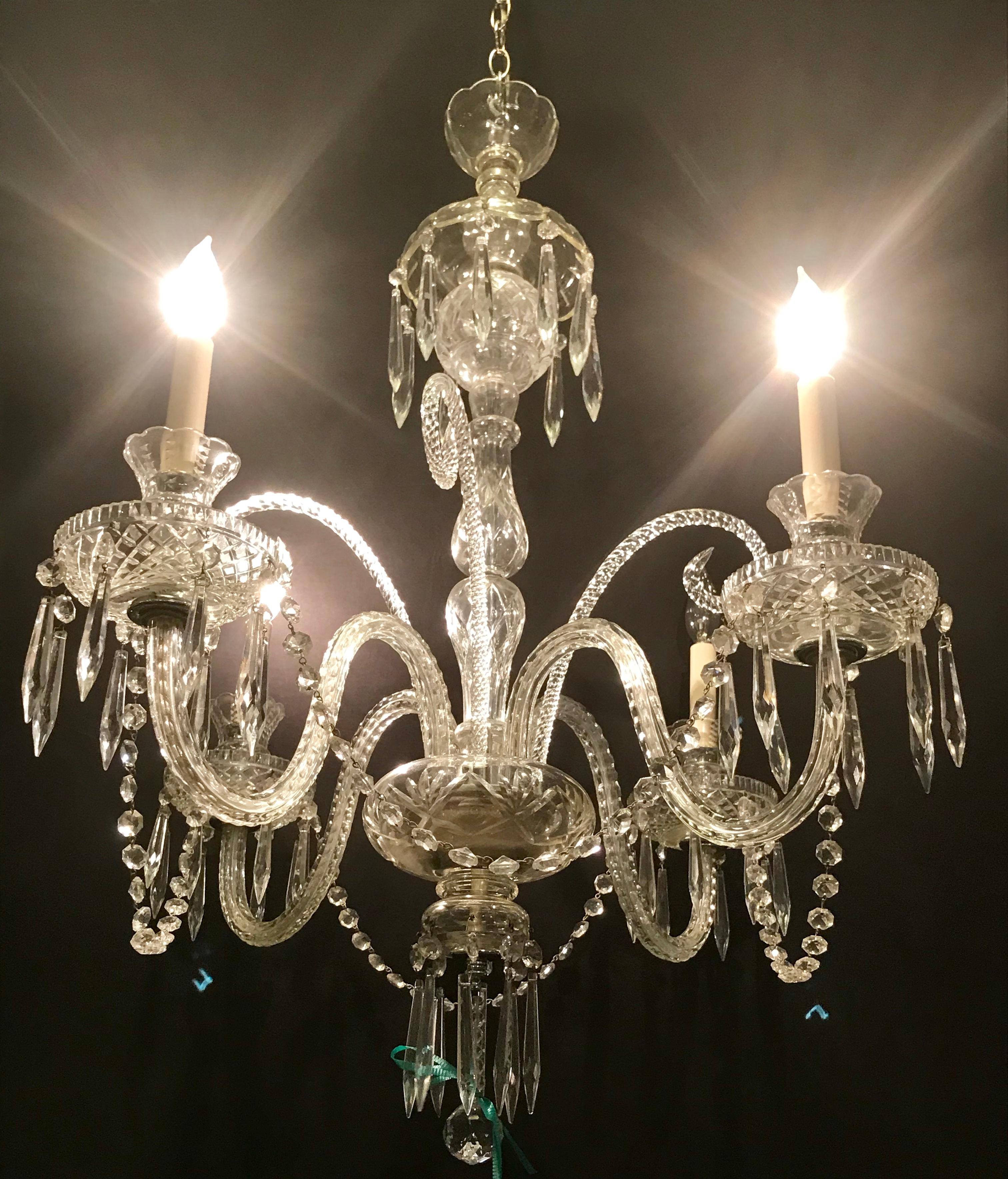 A Hollywood Regency Waterford style crystal 5-light chandelier. Sleek and simplistic is this finely cut crystal light fixture which has been recently rewired and can hang on a chain or mounted to the ceiling.