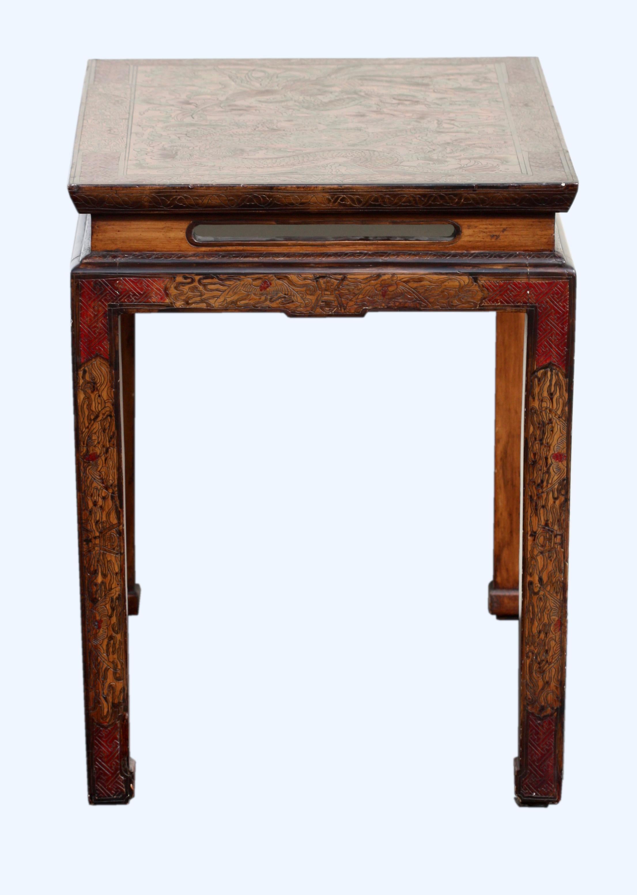A Huanghuali style table, Chinese, Qing dynasty, 19th century
The rectangular paneled top above a straight waist and apron, the legs of square section 
Measures: Height 25.25 in. (64.13 cm.), width 29.5 in. (74.93 cm.), depth 19.75 in. (50.16