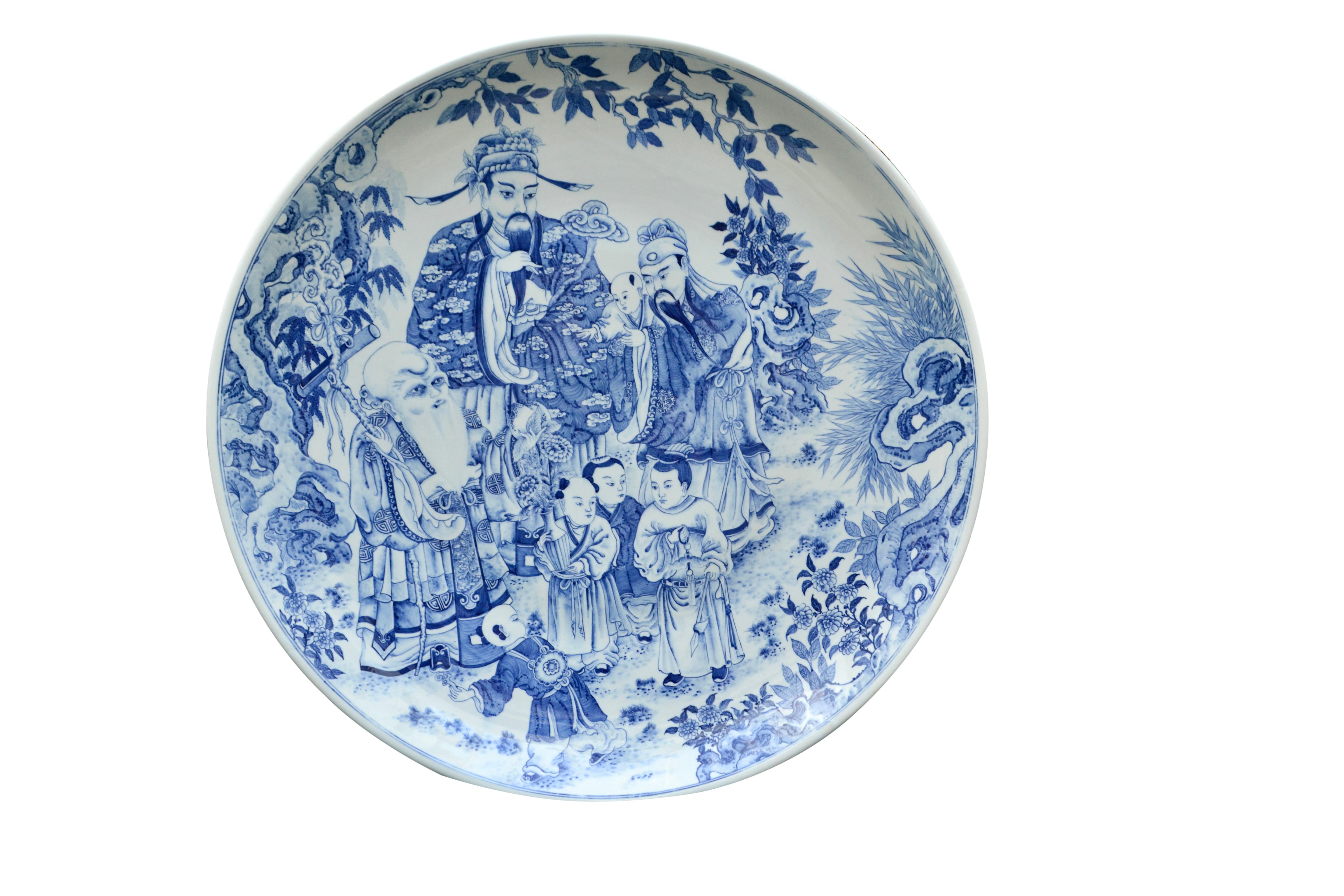 A very large and impressive blue and white Chinese porcelain Charger depicting the Taoist concept of Good Fortune (Fu) Good Stable Income (Lu) and Long Life (Shou). Fu is on the right holding his grand child, Lu is i the middle and the old man on