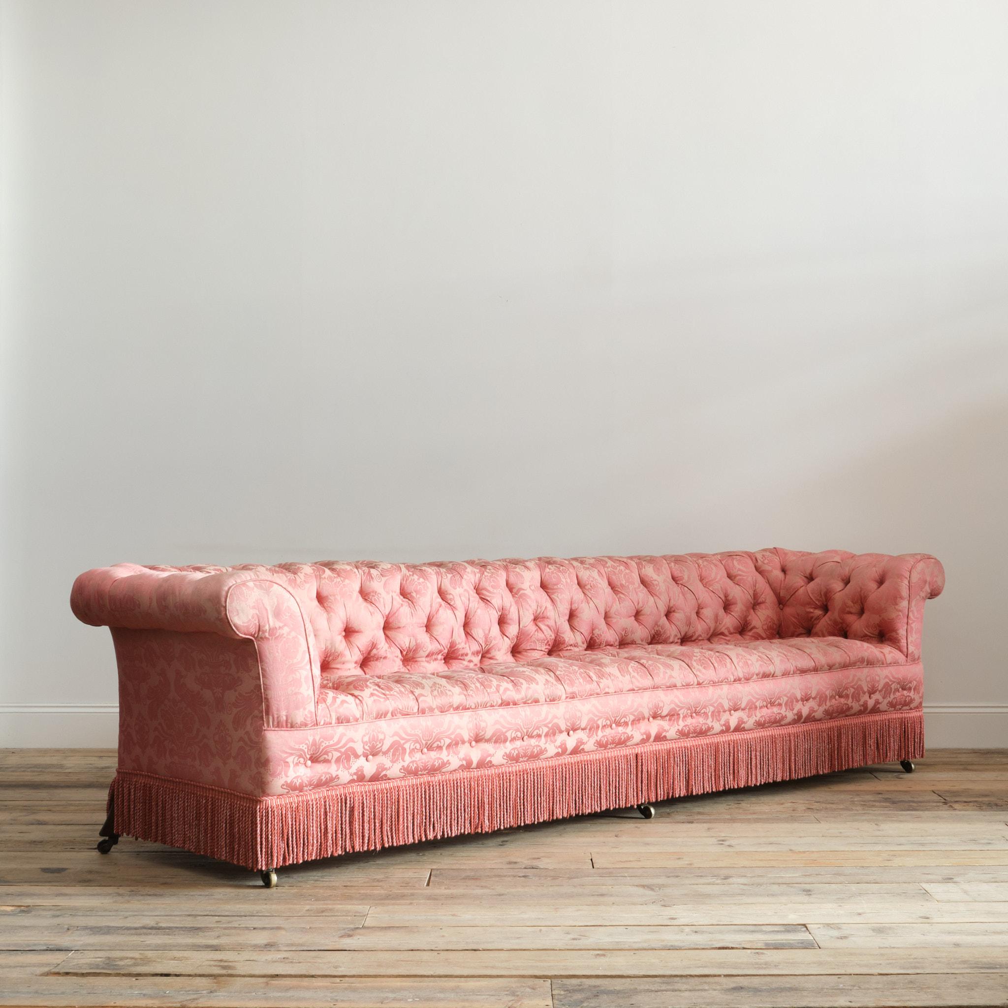A highly unusual and impressive 19th century chesterfield sofa of monumental country house proportions. At over 3 meters wide this sofa is likely a one off bespoke made piece intended for a specific location is a large country house. English
