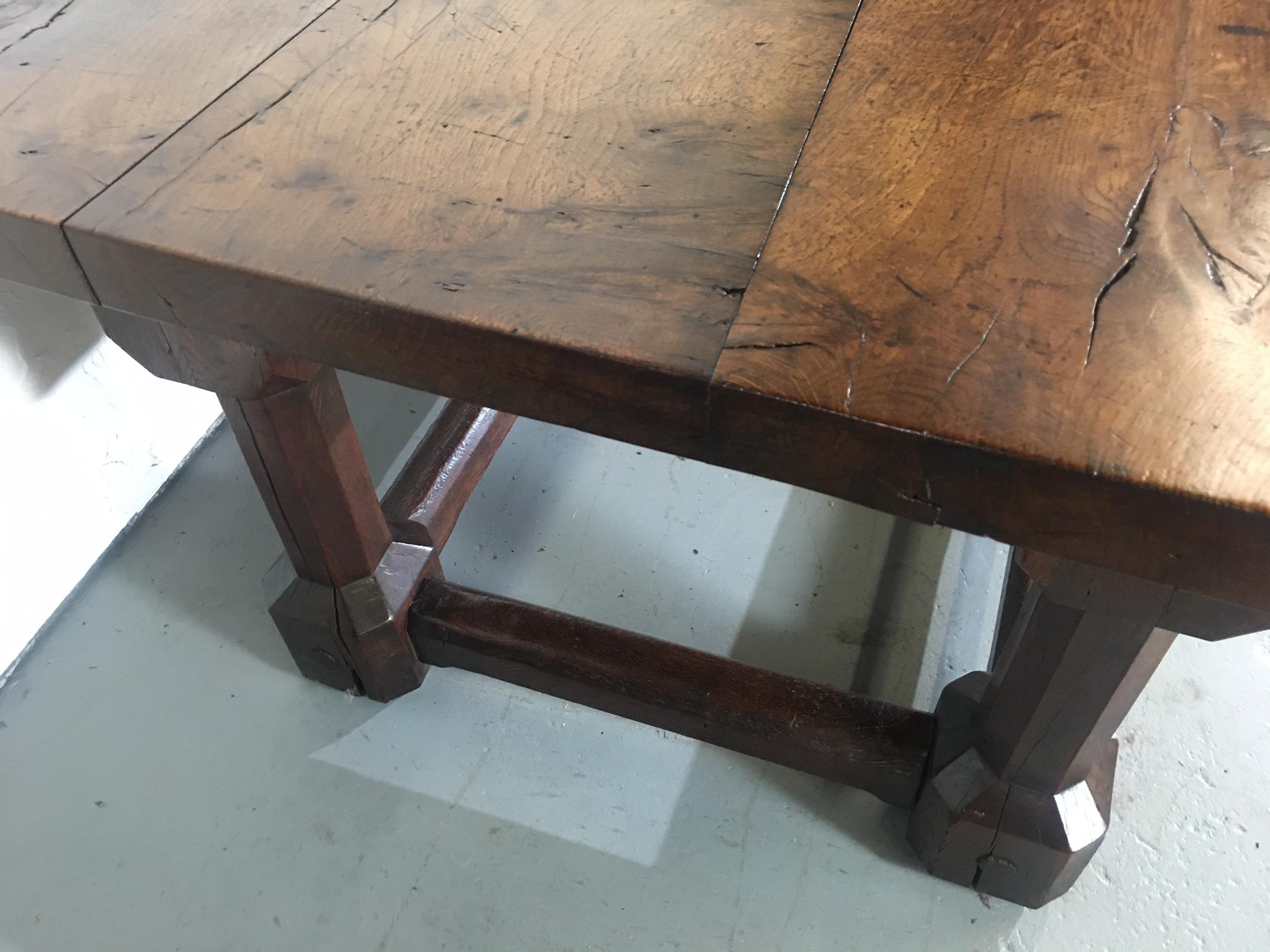 This is a stunning Refectory or Farm Table in solid oak. The size is huge and is over 9.5 feet long. Unusual leg form. Features a single drawer to one end. The patina to the top is exceptional.