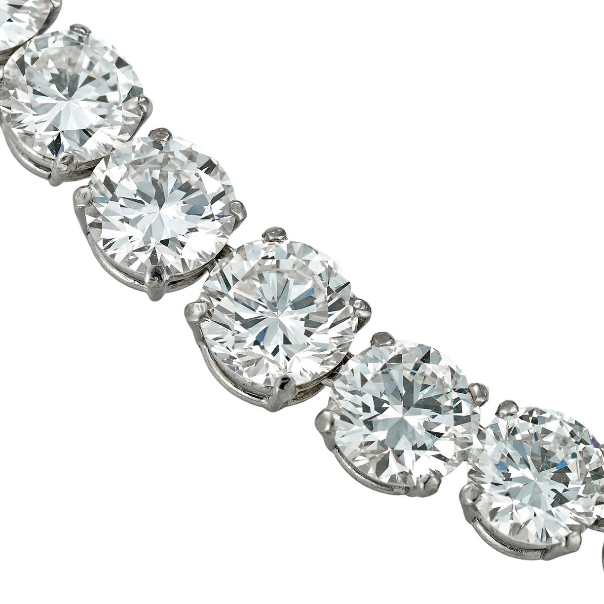 An Important diamond riviere necklace, the eighty-nine round brilliant-cut diamonds graduating from the centre, weighing approximately a total of 30.5 carats, the five larger diamonds, weighing 0.96, 1.16, 1.41, 1.15, and 0.99 carats, accompanied by