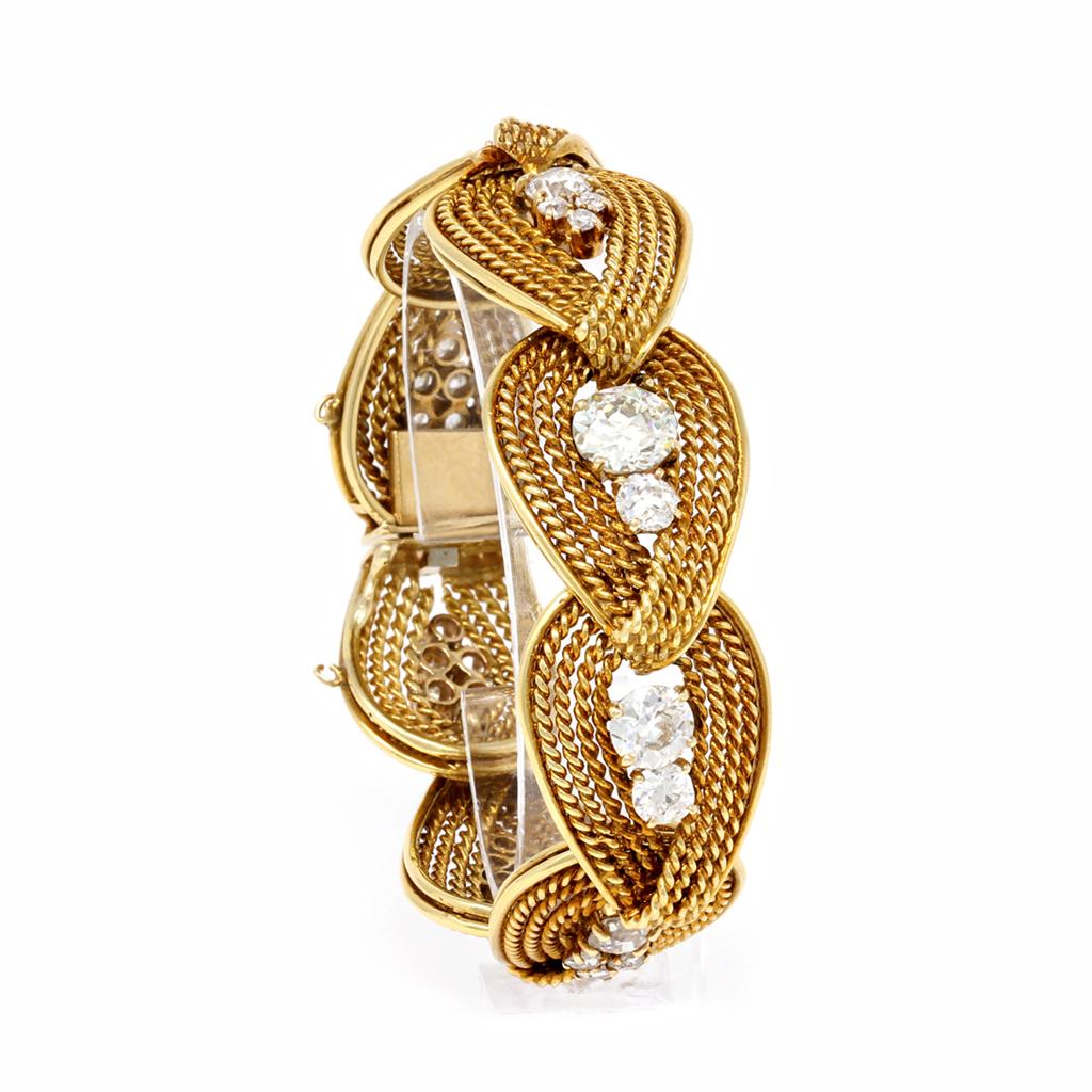 The spectacular Diamond bracelet originated in Italy during the Retro era circa 1940. Each link comprises twisted rope-like gold work centered with a cluster of diamonds. The middle link has a center diamond of 2.25 carats; the second bigger diamond