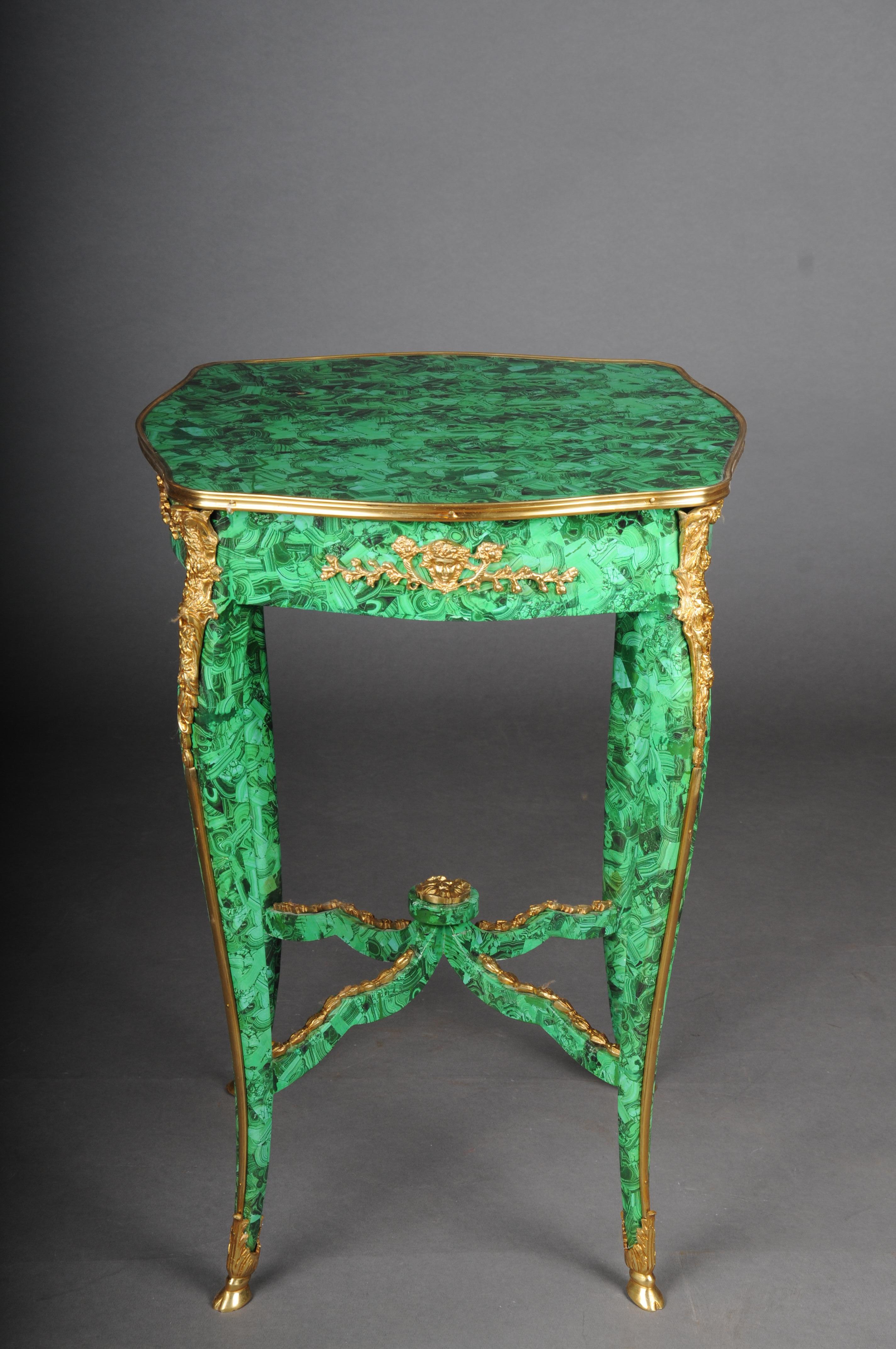A Impressive malachite side table in the Louis XV.

Malachite look painted on solid beech wood. very decorative and elegant. Finely chased and gilded bronze fittings. Cover plate framed with brass. High slightly curved legs ending in sabots. Legs