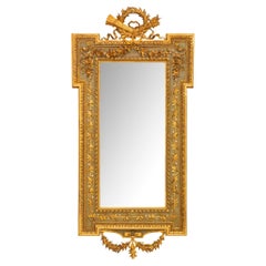 A Italian 19th century Louis XVI st. patinated and Giltwood mirror