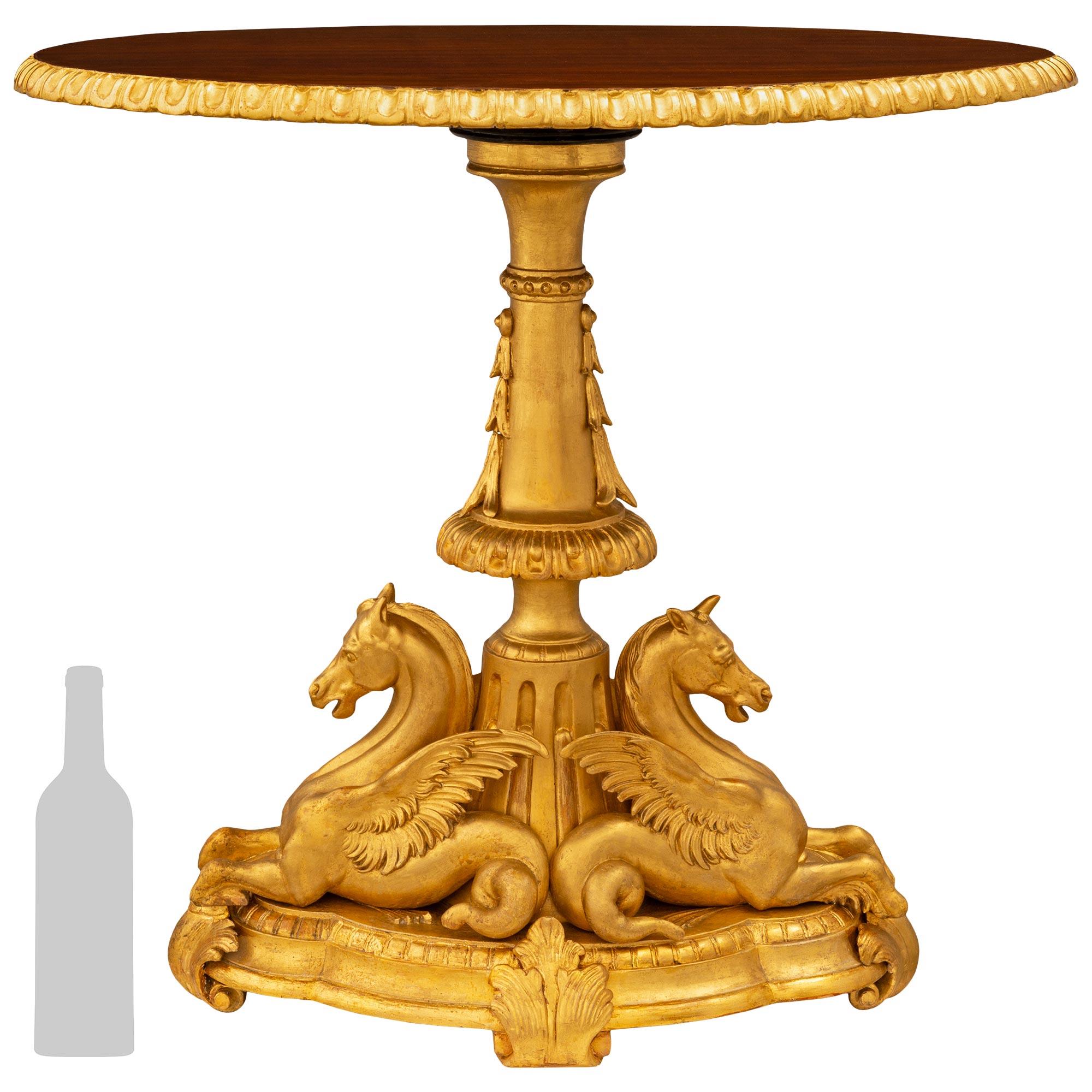 A stunning and very decorative Italian late 18th century Baroque st. Giltwood and Walnut side table. This beautiful side table is raised by a scallop shaped mottled Giltwood base with dentil patterned designed along the top edge and supported on