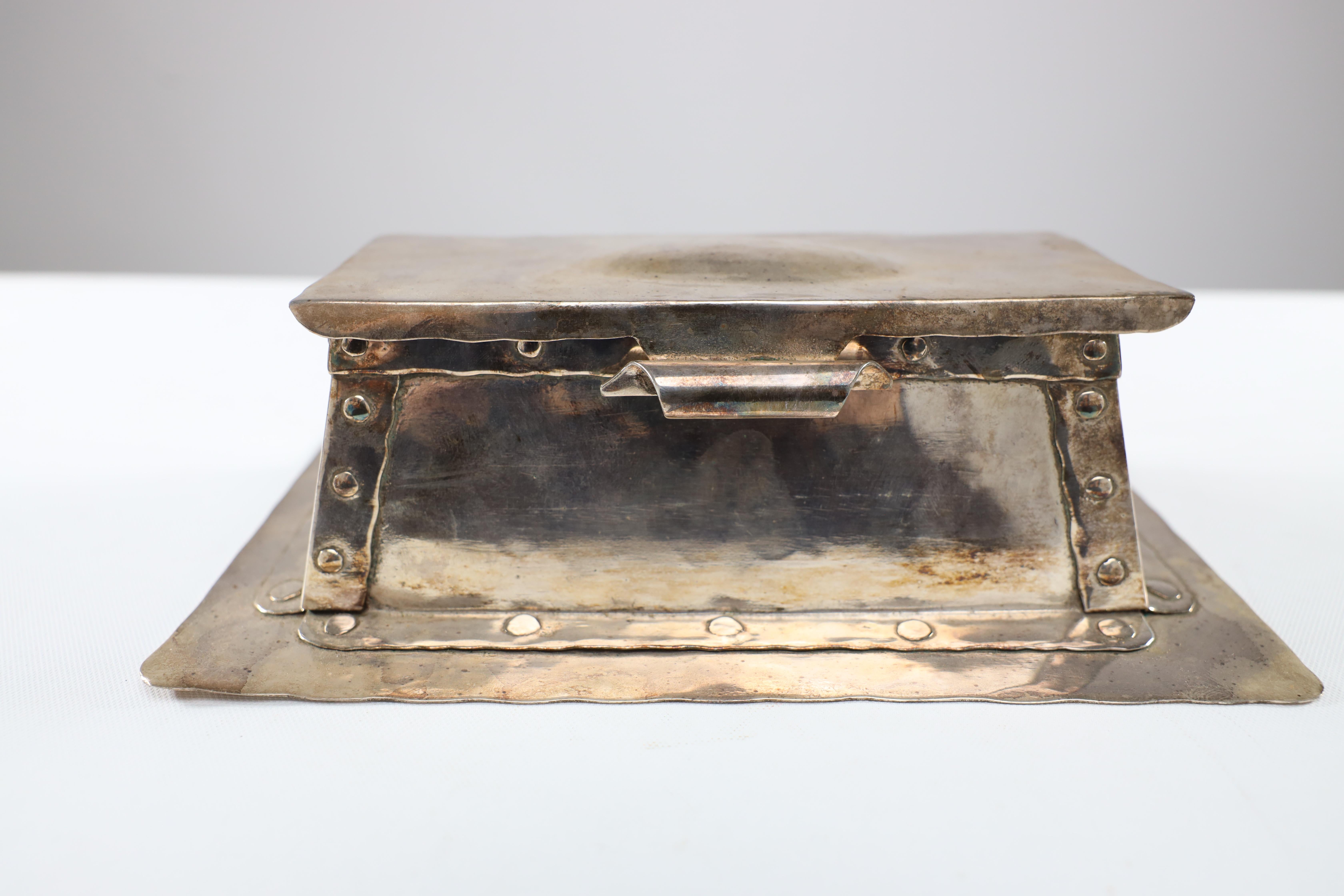 Arthur John Seward of Birmingham.
An Arts and Crafts hammered electro-plated double inkstand, stamped mark.

  