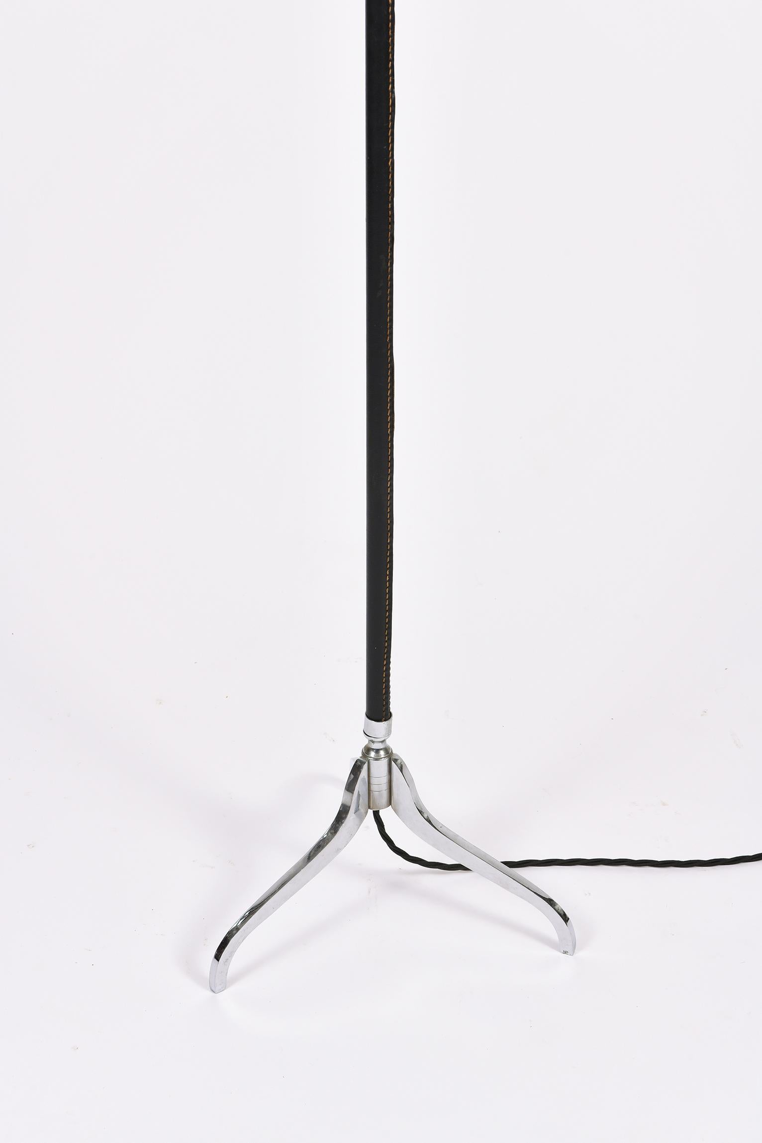 French A Jacques Adnet Style black leather and nickel plated brass tripod floor lamp