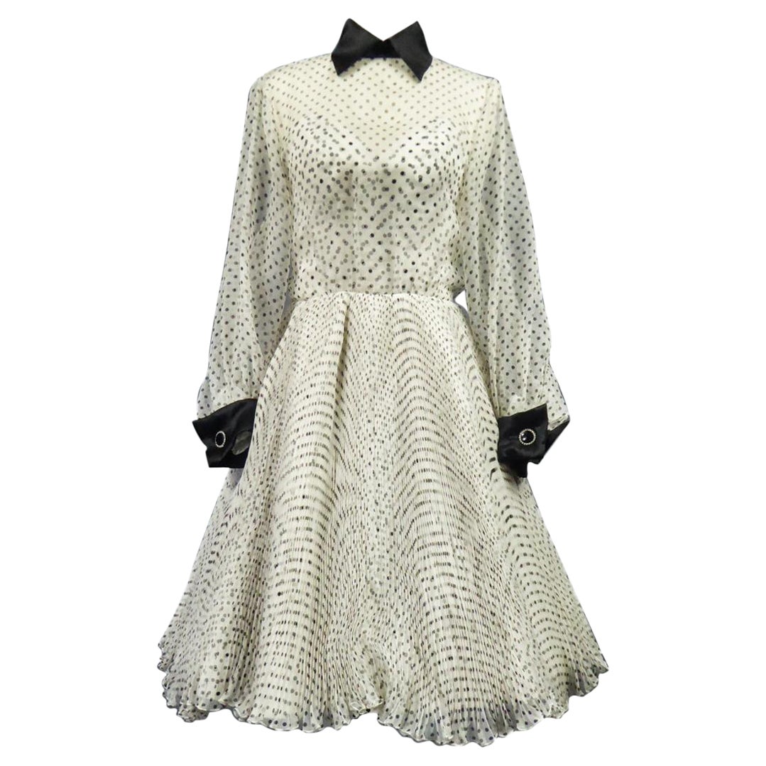 Circa 2000
France
Nice Fresh evening dress in silk organza printed with black polka dots from the designer house Jacques Fath, from the wardrobe of Princess Diane of France Circa 2000. Overlay effect of the finely pleated organza of the skirt on a