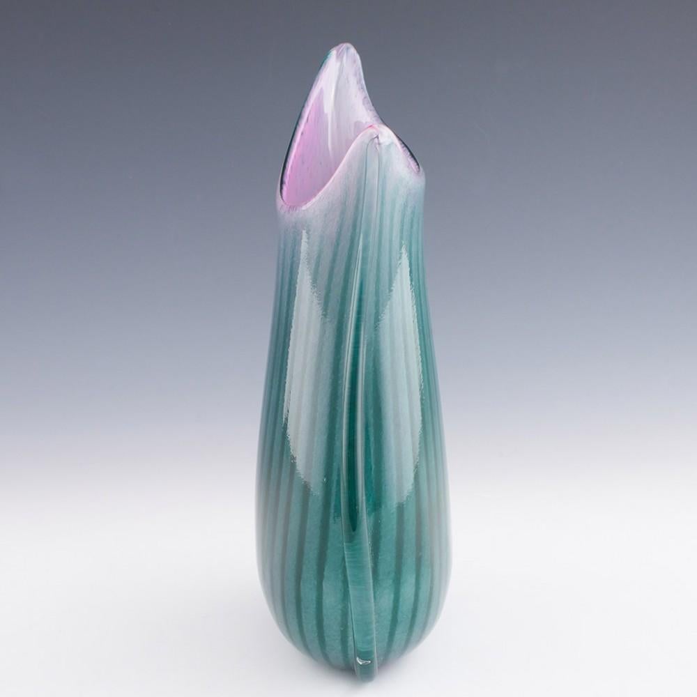 Heading : A Jade and Rose Fishtail Vase by Siddy Langley
Date : 2023
Origin : Cullompton , Devon
Bowl Features : A rose pink mottled interior with mottled jade green exterior. Cases in vlear glass with deep jade green stripes and clear glass
