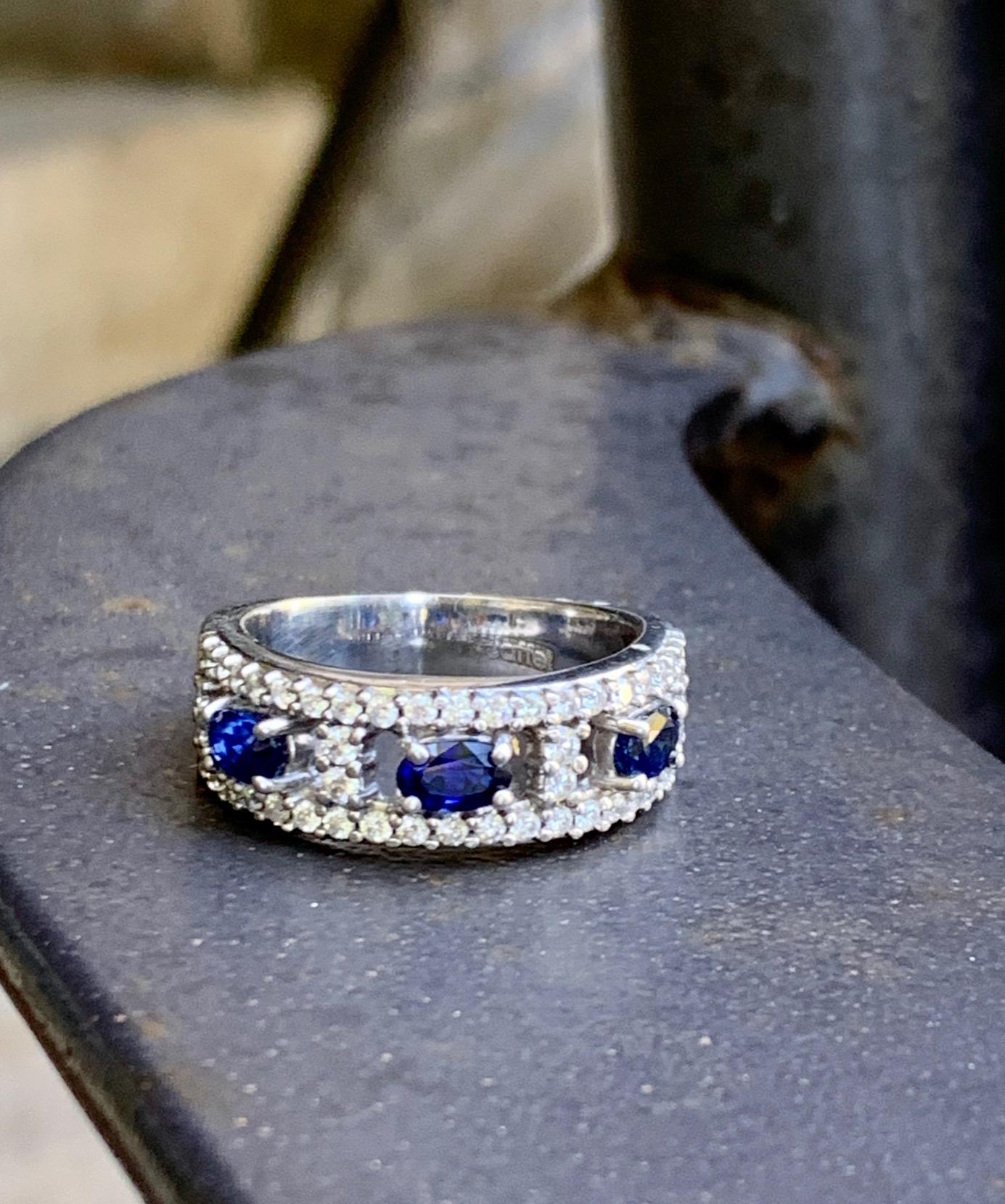This beautiful ring features three 5x3mm oval, faceted blu Sapphires and 46 1.5-1.8mm brilliant cut Diamonds totaling approximately 1.10ctw.  Grade: VS-G/H

Size: 8 1/2 - This ring can be resized, but G. Lindberg Jewels does not provide sizing