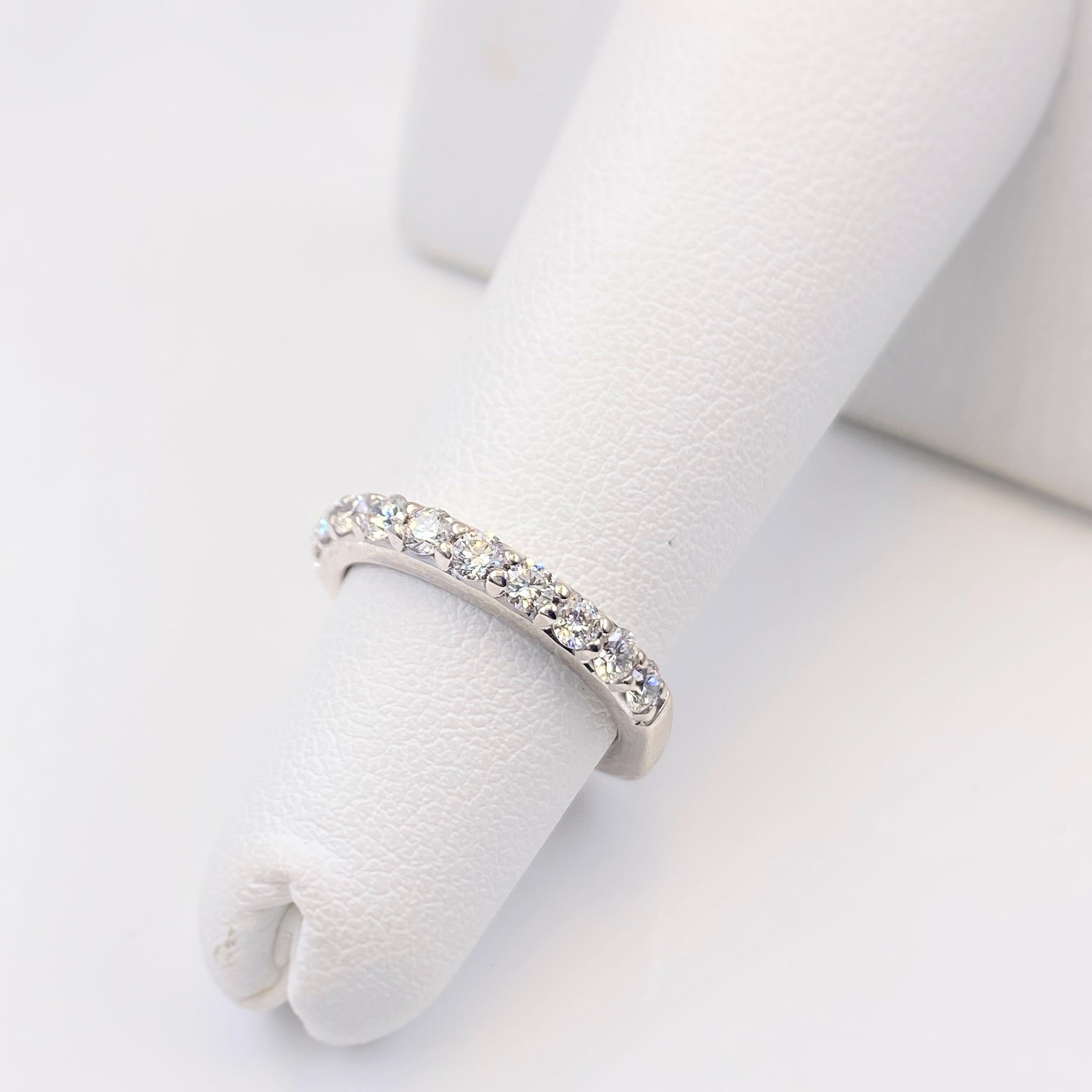 A. JAFFE Diamond Wedding Band
Style:  Prong Set
Metal:  18kt White Gold
Ref. #:  MRS868 
Size:  3.25
Width:  2.5 MM
TCW:  0.45 tcw
Diamond:  10 Round Brilliant Diamonds
Color & Clarity:  G - VS
Hallmark:  ©18KT A.JAFFE
Includes:  Elegant Ring