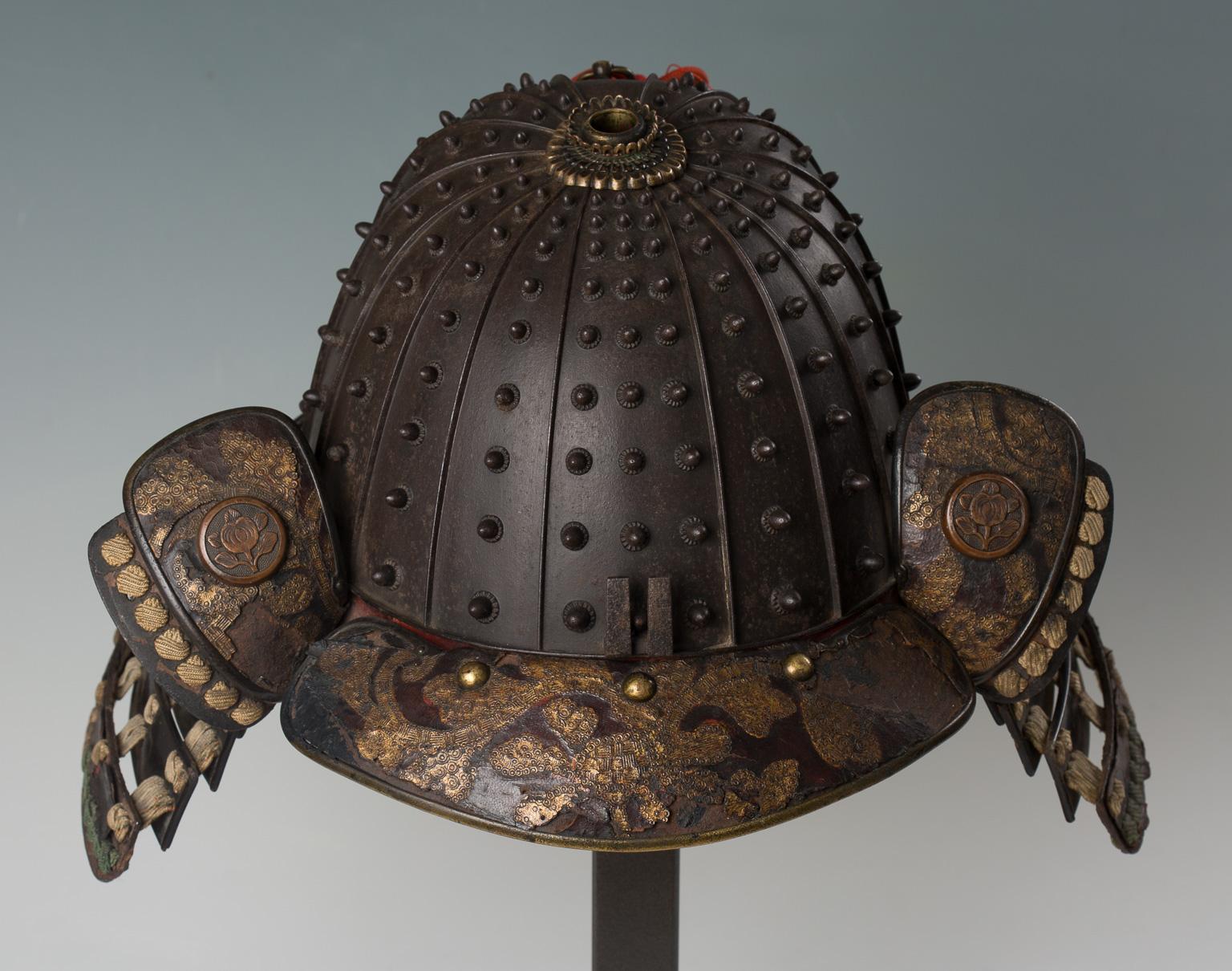 This heavy helmet is typical of the work of the armor makers in the province of Kaga. Each plate is fitted with a row of nine rivets of diminishing size toward the top, with the exception of the front and rear plates, the former with three rows of