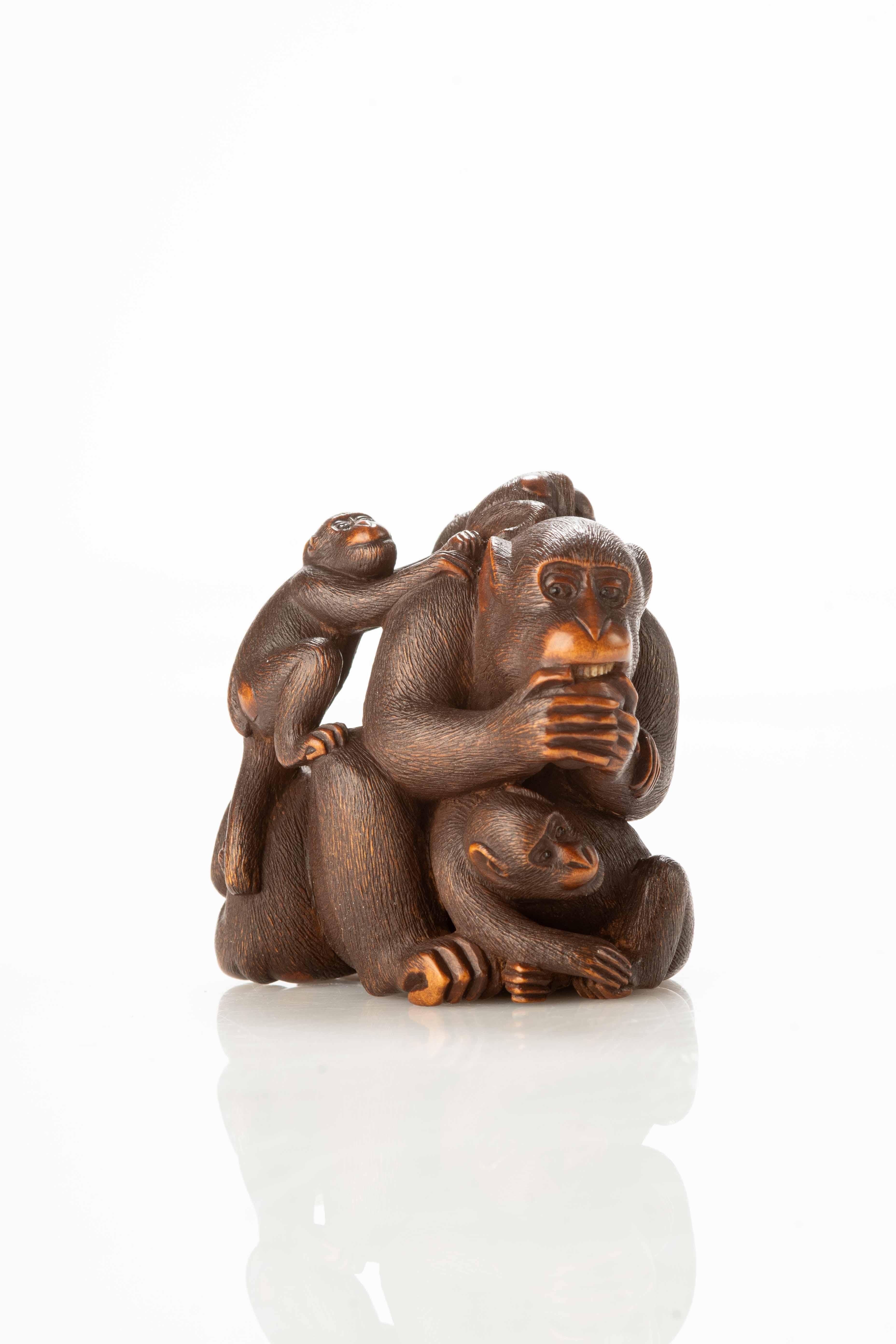 19th Century A Japanese boxwood netsuke depicting a group of five monkeys