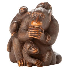 Antique A Japanese boxwood netsuke depicting a group of five monkeys