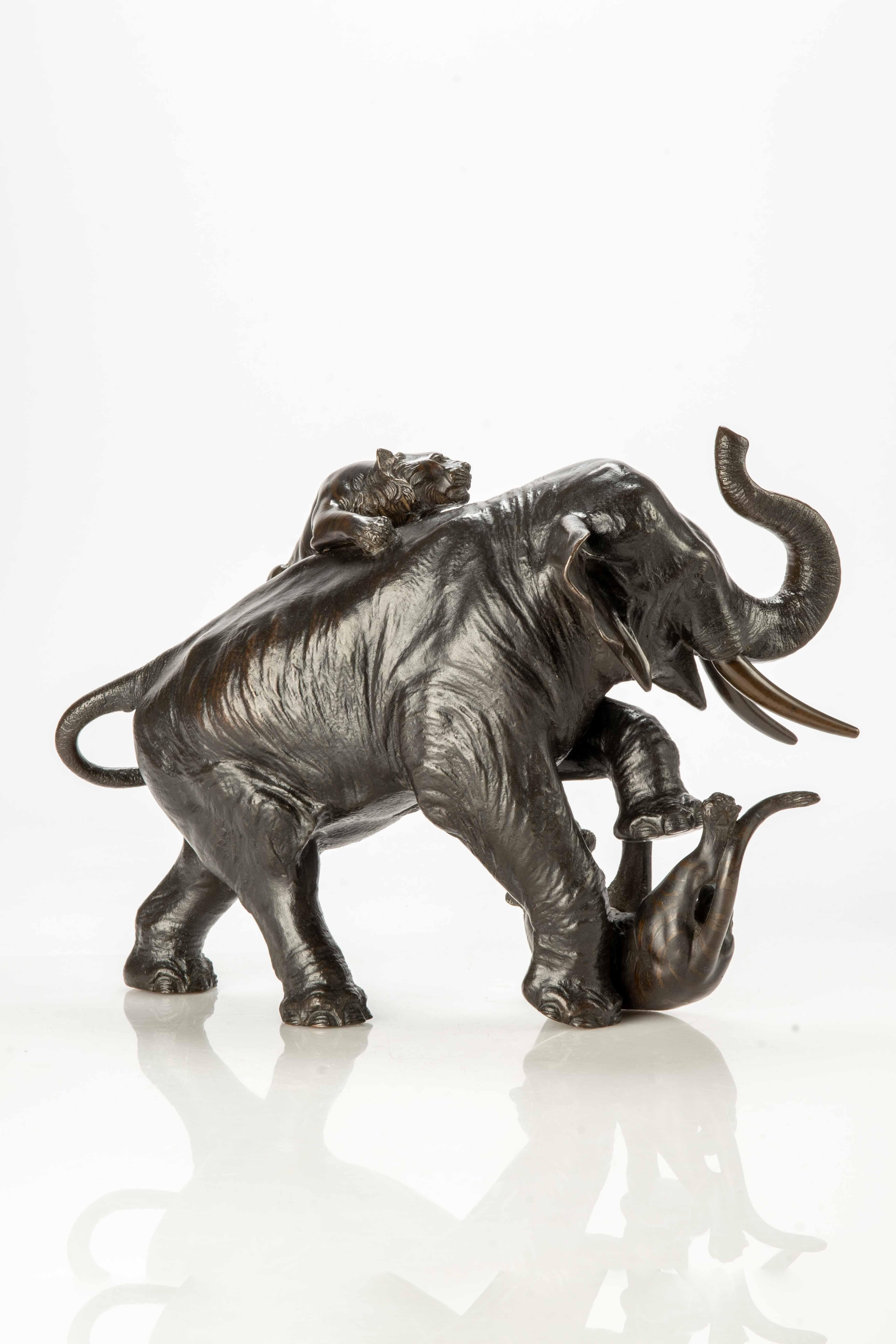 Metalwork A Japanese bronze okimono depicting an elephant with two tigers For Sale