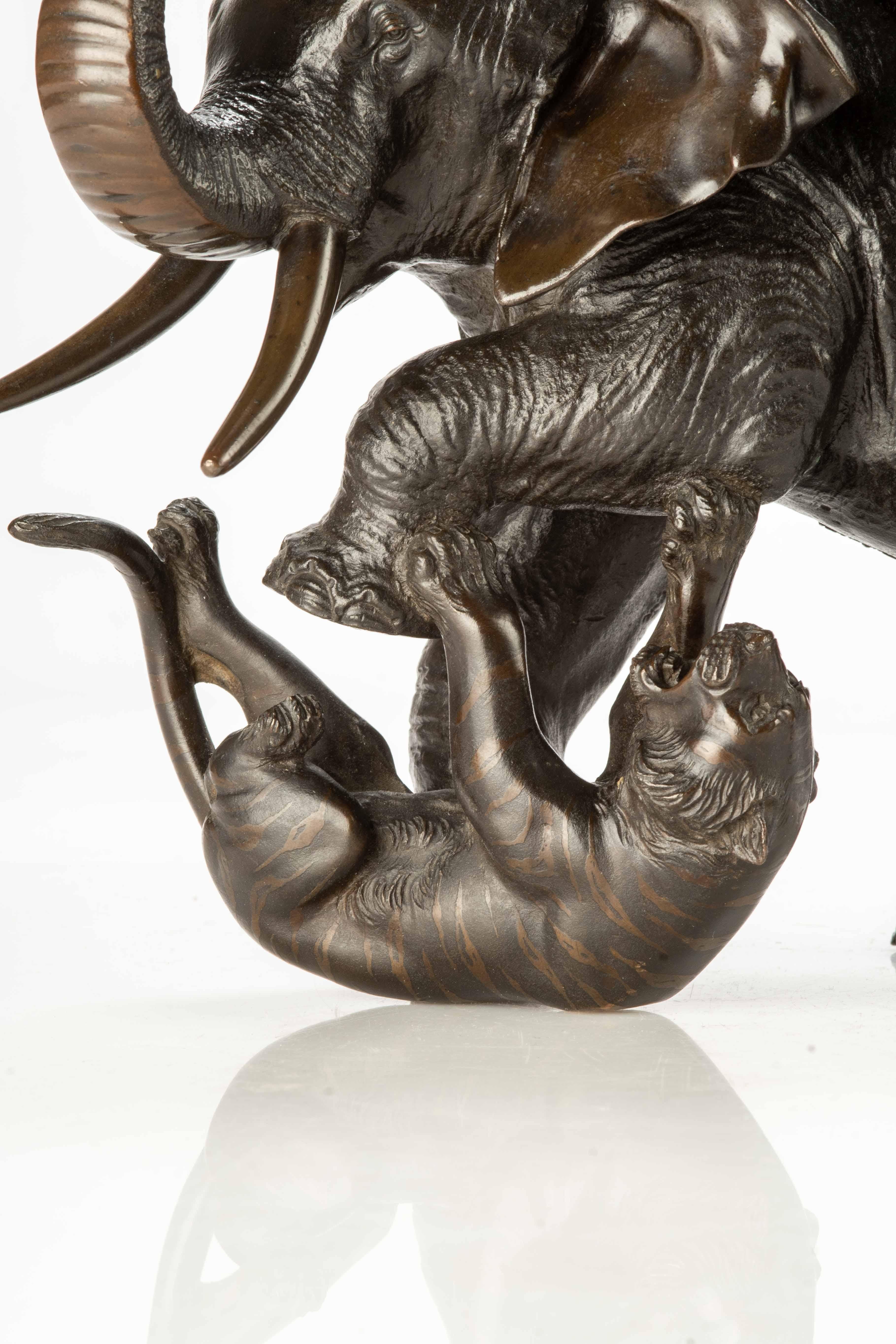 19th Century A Japanese bronze okimono depicting an elephant with two tigers For Sale