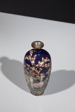A Japanese cloisonné vase decorated with a flower garden and a maple tree