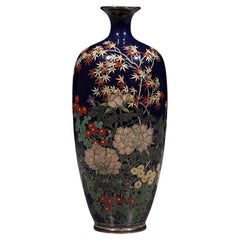 A Japanese cloisonné vase decorated with a flower garden and a maple tree
