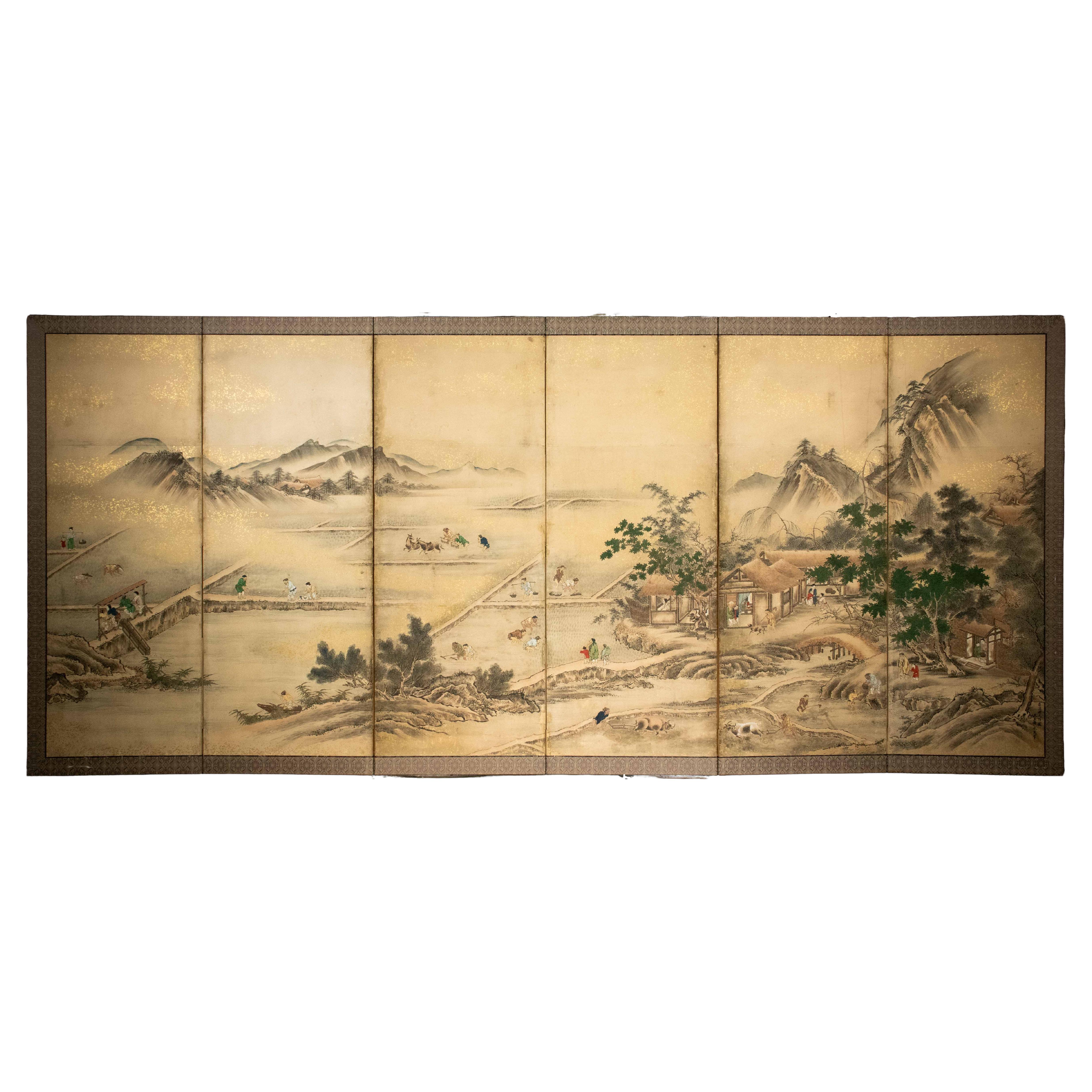 A Japanese folding screen depicting an agricultural landscape, signed Eisho Kano in vendita