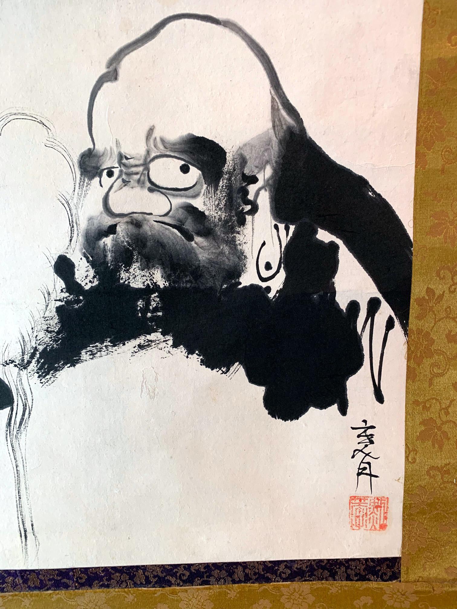 Sumi ink on paper, mounted with brocade borders as a kakejiku (hanging scroll), the painting depicts Daruma, the historical Bodhidharma, who reputedly brought Chan Buddhism to China at the beginning of the 6th century. The Chan further spread to