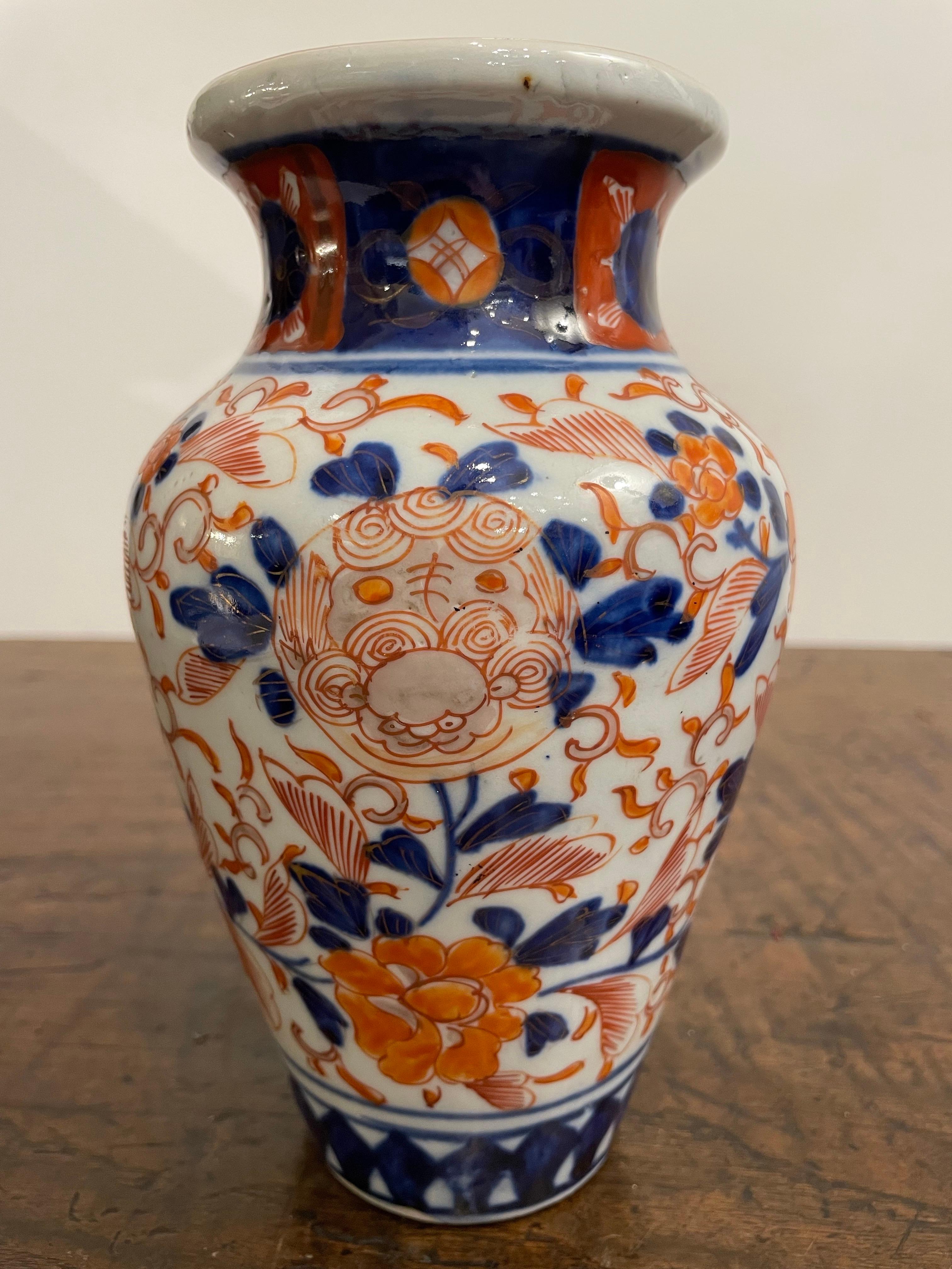 A Japanese Imari Vase, 19th Century

Provenance: Private Australian Collection.

Description:
The body embellished with a repeating design of flowers and dragon cartouches united by foliate scrolls, above a chevron band to the base, the neck with