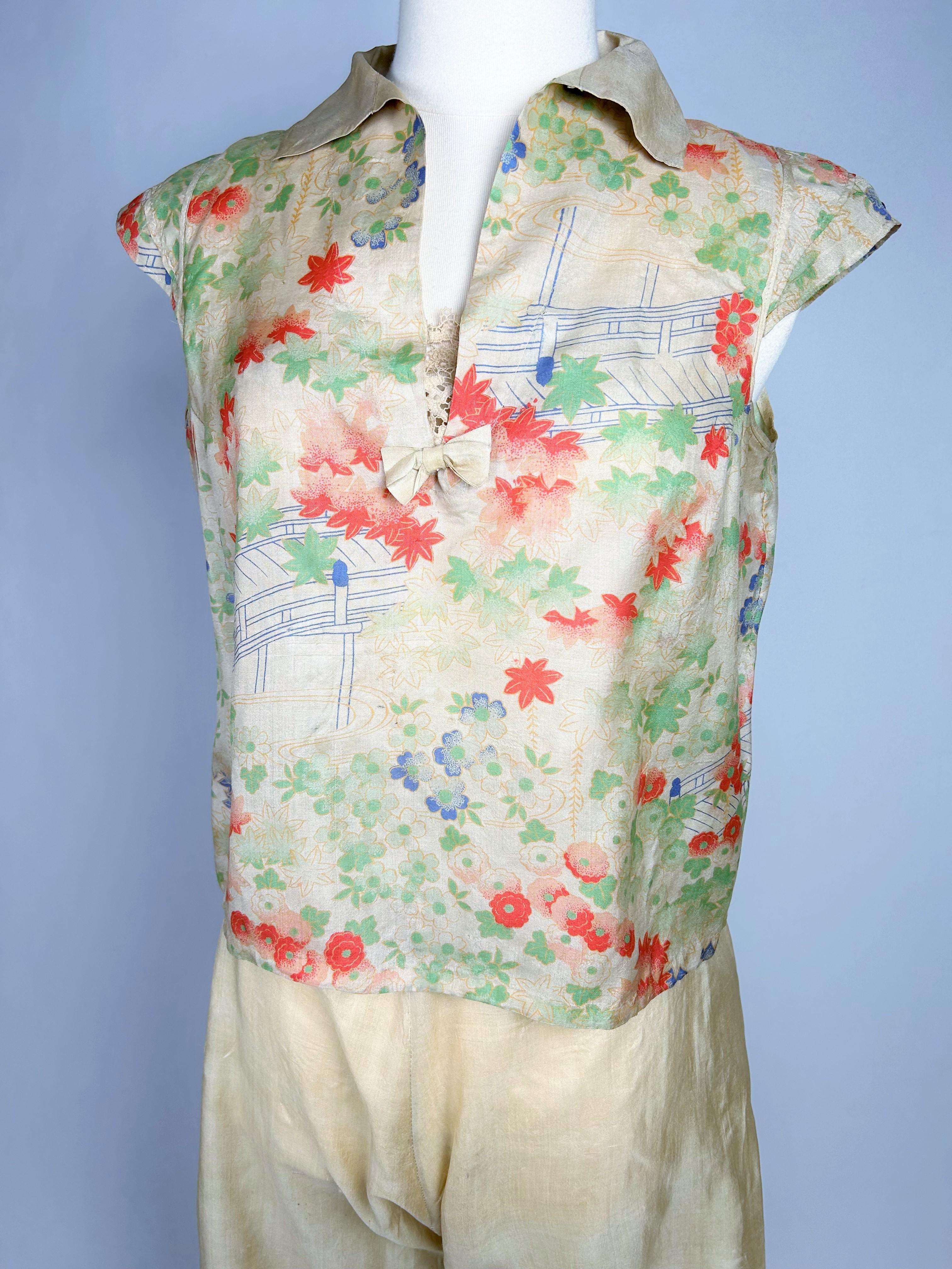 Circa 1930

France

Beautiful evening pyjamas, two pieces trousers and bodice in printed silk pongee dating from the 1930s. Beautiful print with Japanese floral decoration in soft colours. High waist trousers with elephant feet (30 cm wide) printed