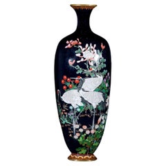 A Japanese Manchurian cranes cloisonné vase decorated with polychrome enamels 