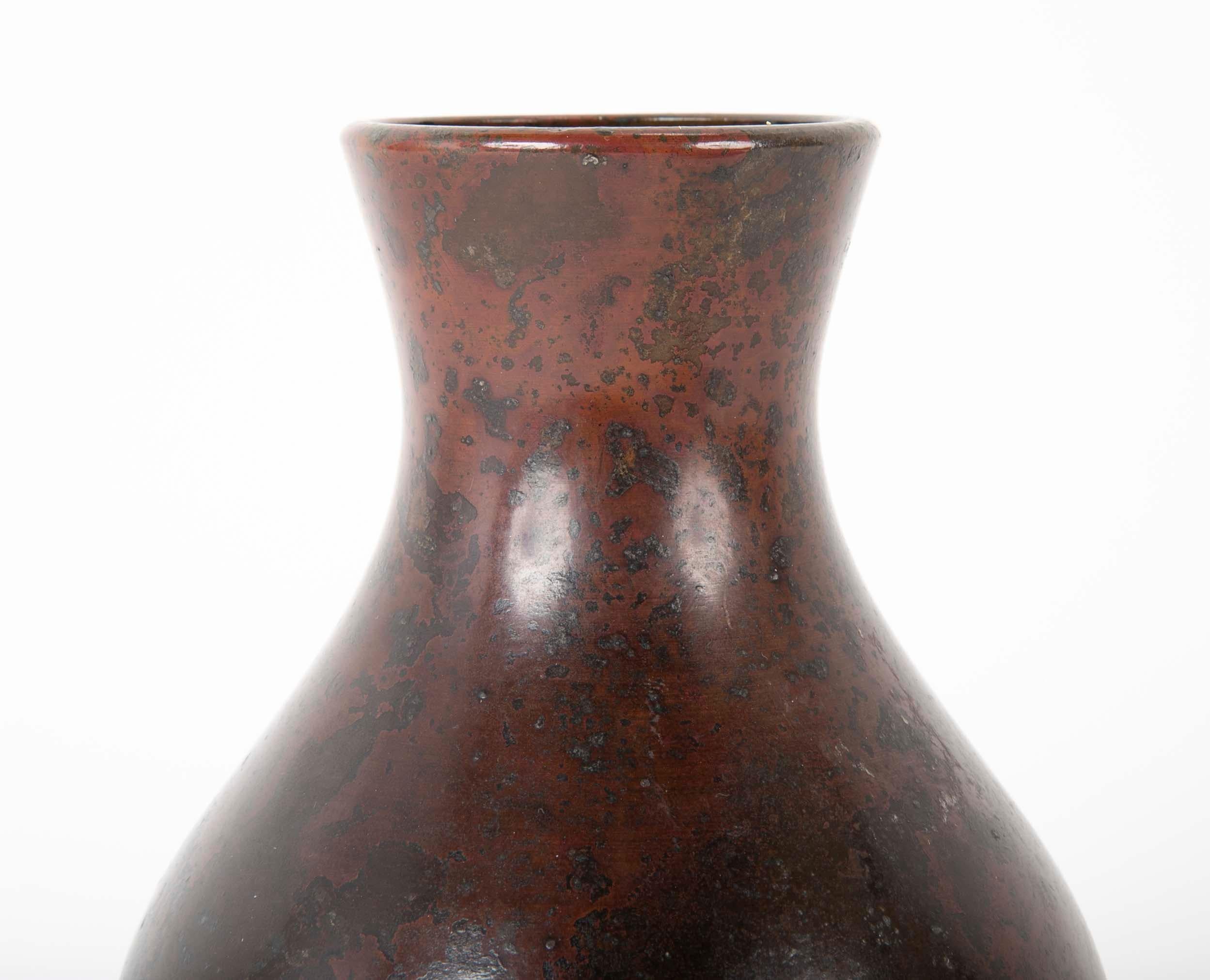 A Japanese Meiji period (1868-1912) bronze Ikebana vase patinated using a Murashido oil technique.