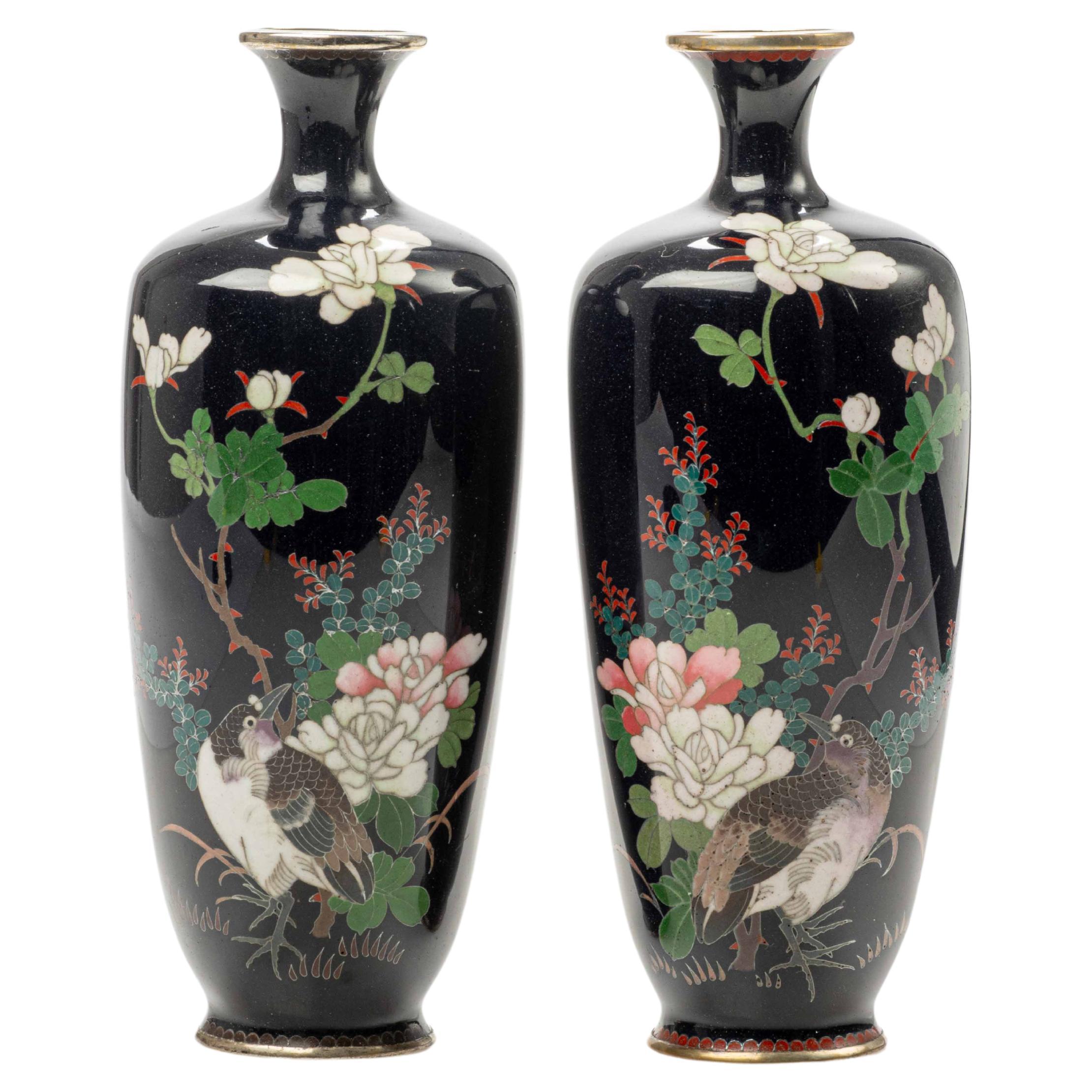 A Japanese pair of cloisonné enamel vases decorated with silver wire