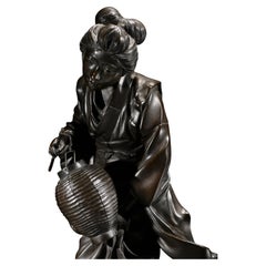 A Japanese Tokyo School Bronze Okimono Depicting a Walking Geisha