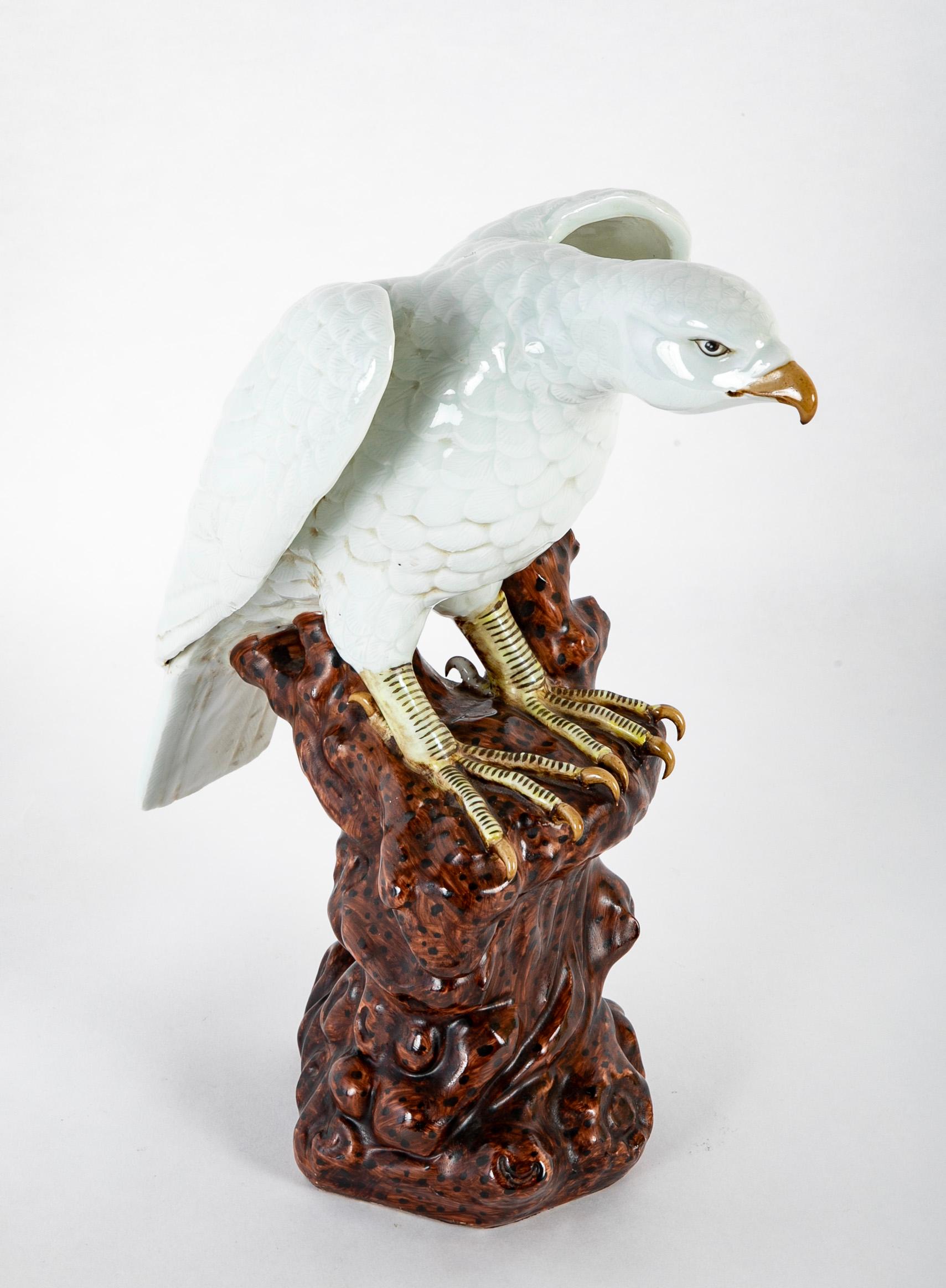 A 19th century Japanese white glazed porcelain hawk perched on a tree stump. 