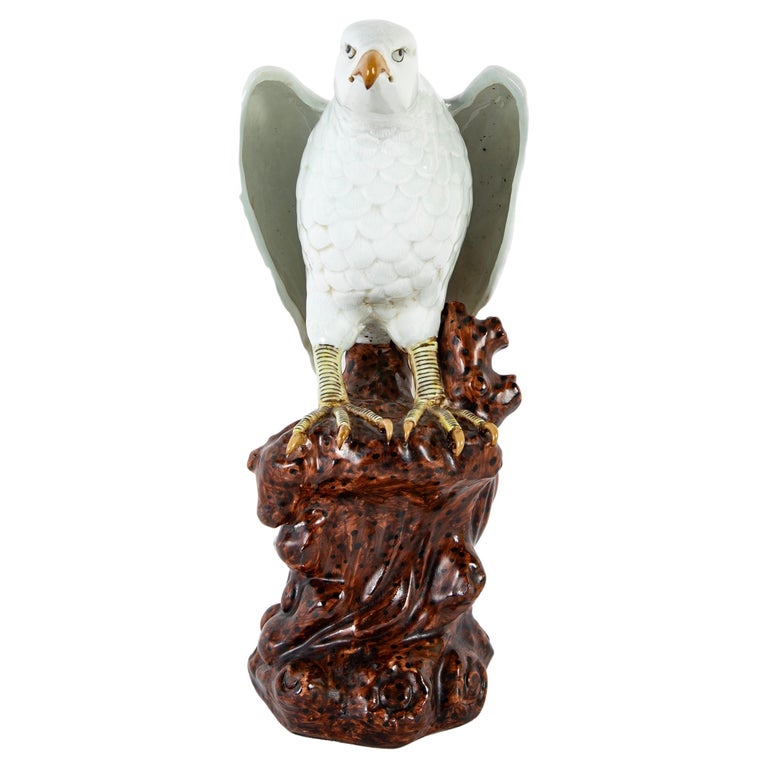 A Japanese White Glazed Porcelain Hawk Perched on a Tree Stump A Japanese White Glazed Porcelain Hawk Perched on a Tree Stump