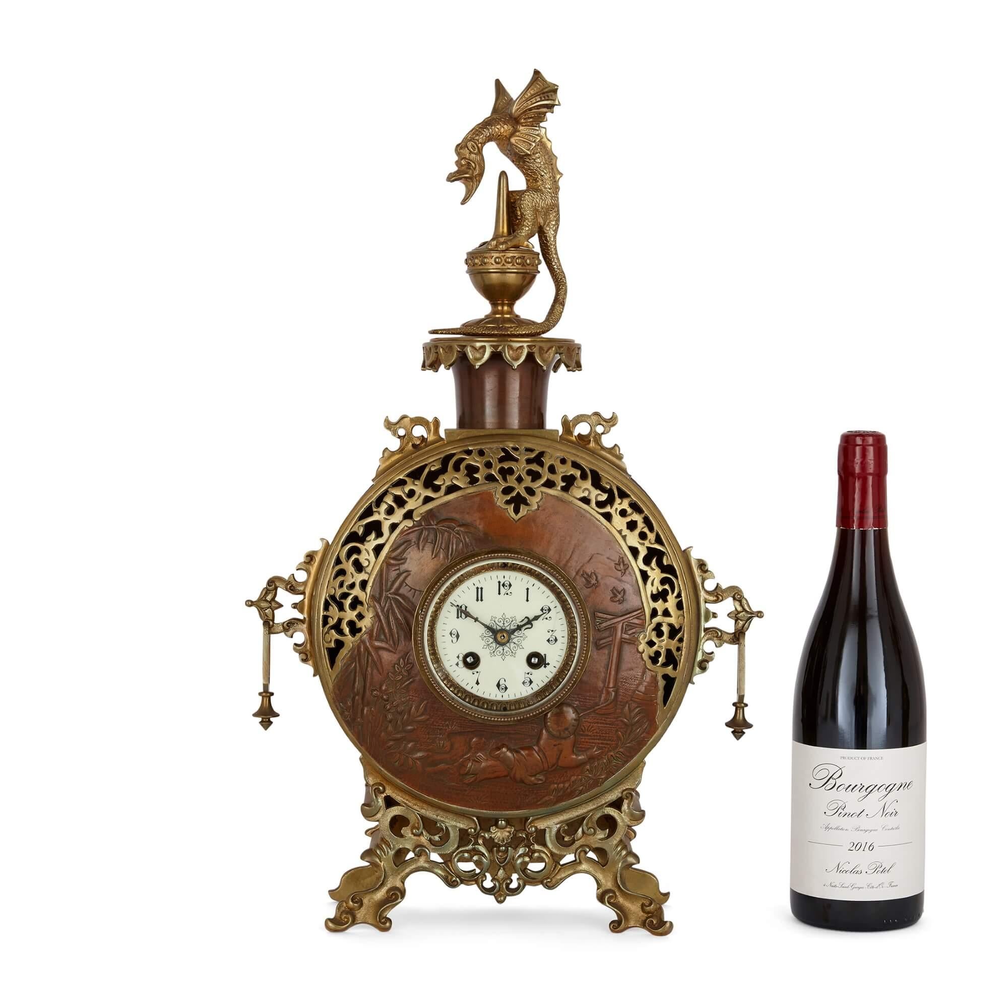 A Japonisme gilt-bronze and brass three-piece clock set
French, Late 19th Century
Clock: height 52cm, width 31cm, depth 12cm
Candelabra: height 55cm, width 32cm, depth 9cm

Made in France in the late nineteenth century in the popular Japonisme