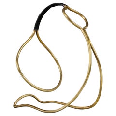 A Jaques Adnet brass and leather bottle carrier