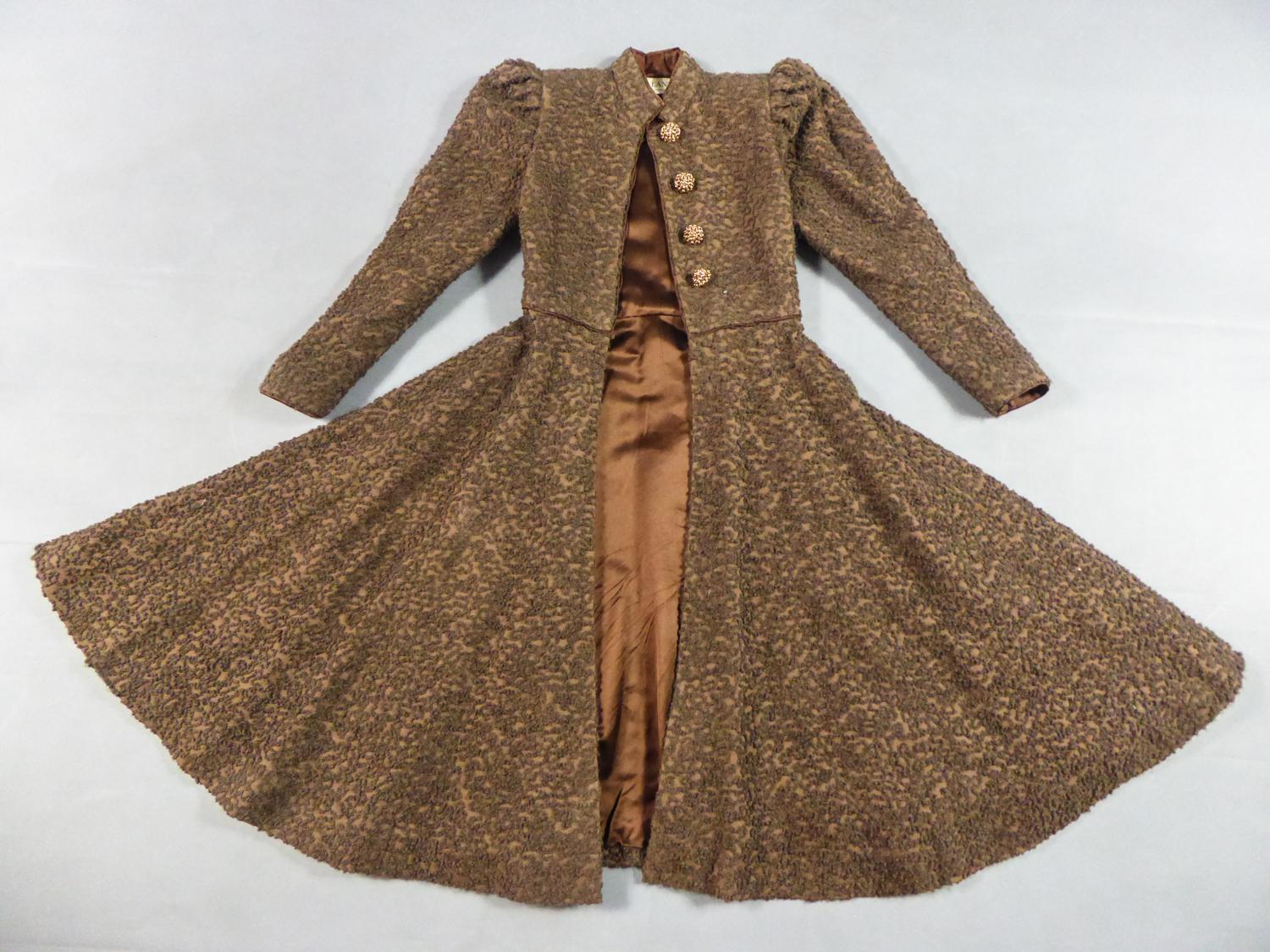 Circa 1945
France

Dress-Coat or Redingote in chestnut curly wool from the Haute Couture Designer House Jeanne Lanvin probably before her death around 1945. Astonishing brocaded Jacquart background in curlt wool with loops and vermiculated