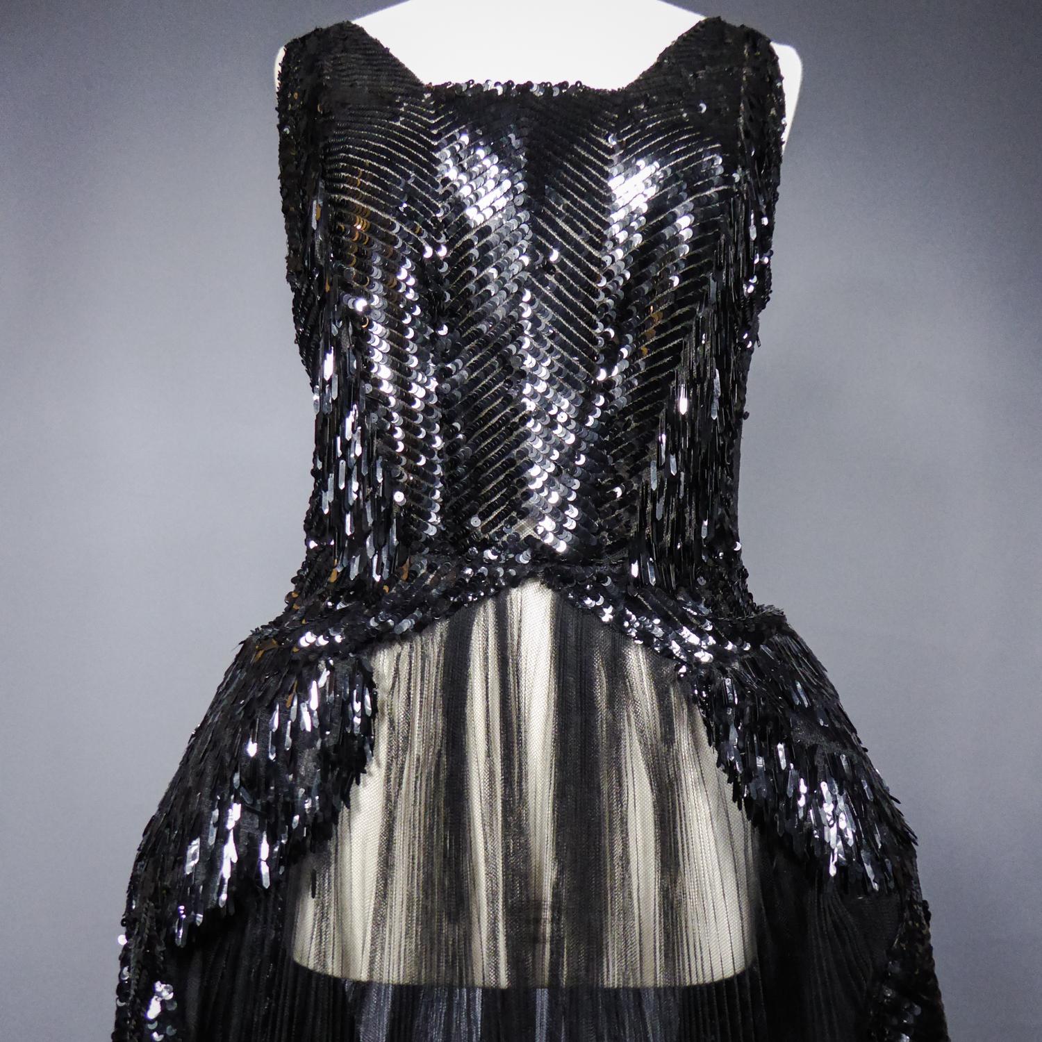 Circa 1930
France or Europe

Astonishing dress with small panniers known as Robe de Style celebrated by Jeanne Lanvin and dating from the years 1925/1935. Sleeveless dress, square low-cut neckline in front and pointed in the back. Bustier and side