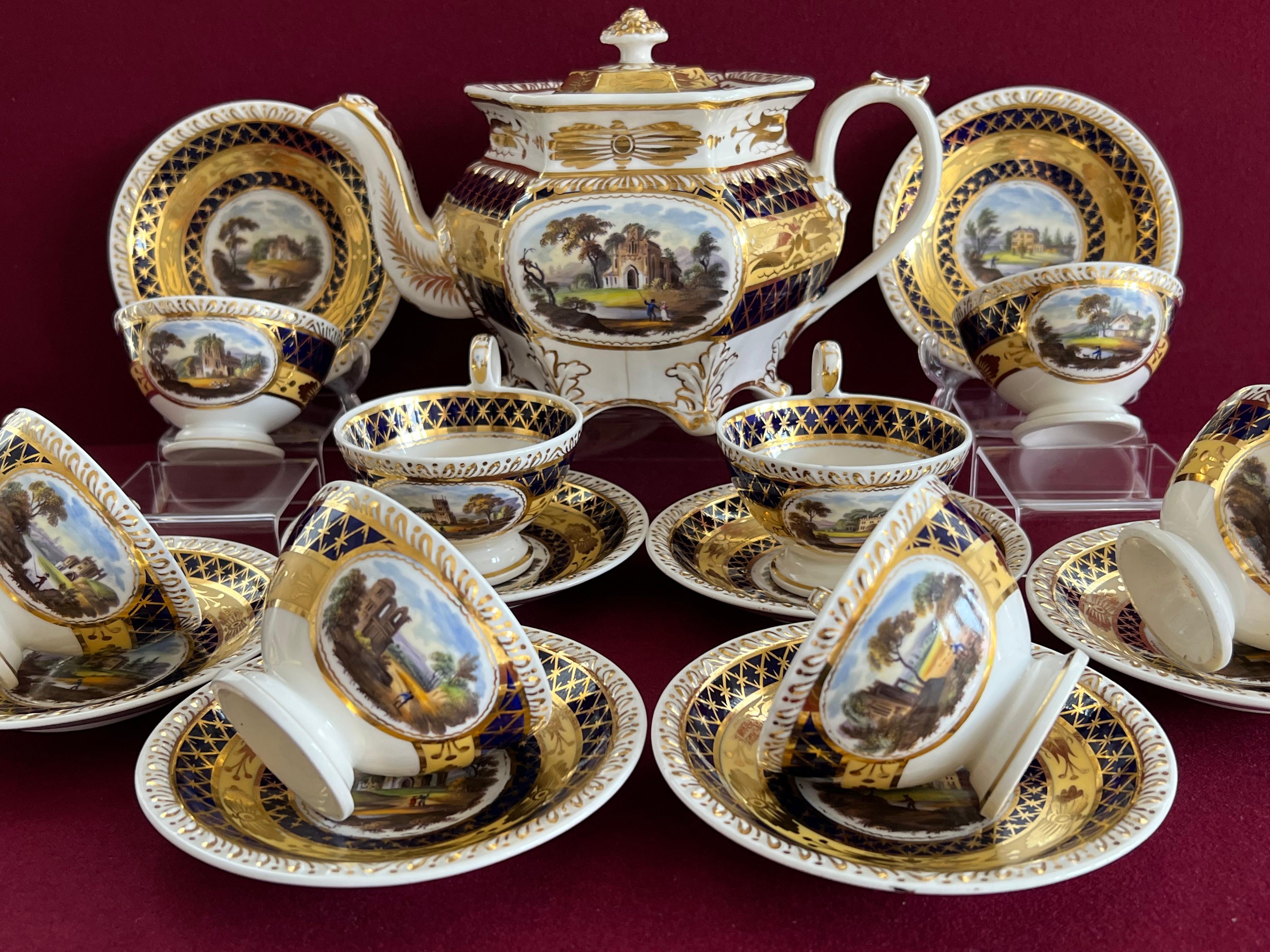 A John & William Ridgway part tea service c.1825. Consisting of 8 teacups and saucers and a teapot. Finely decorated with pattern 2/1387 gadrooned edge shape. Bone china. Bands of mazarine blue with criss-cross gilding and straw with floral gilding.