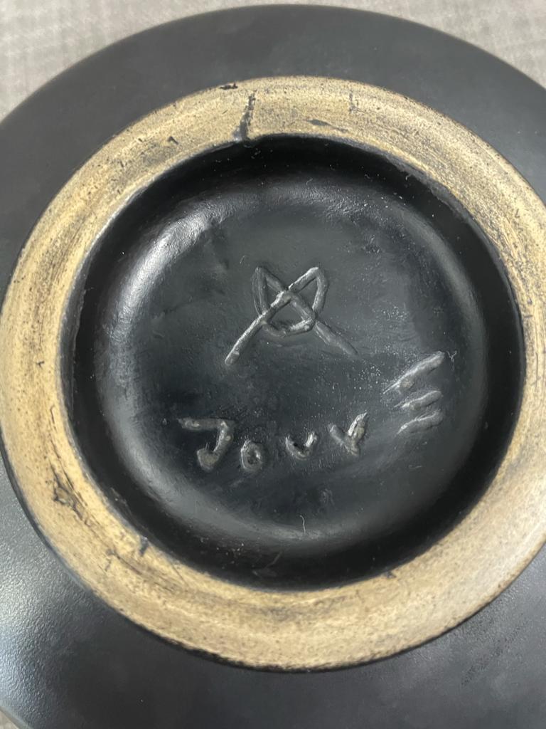 A black little vase signed JOUVE.