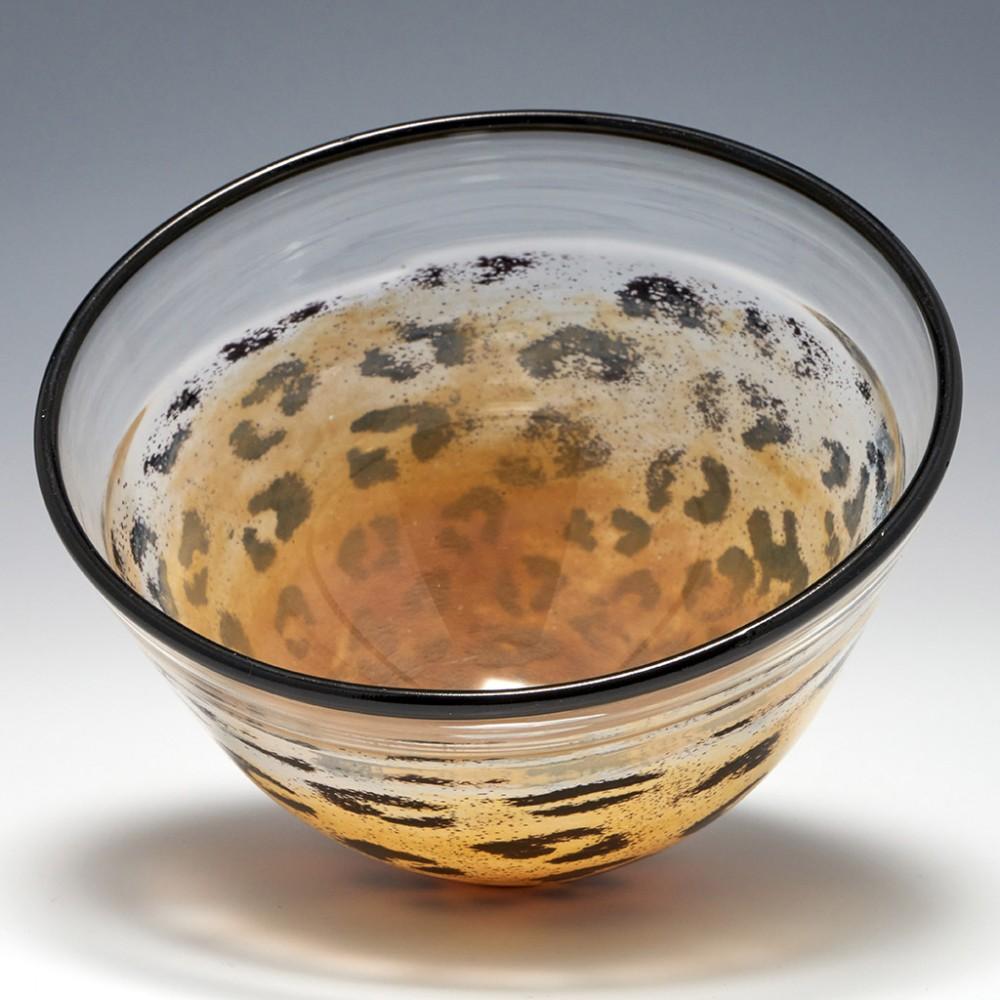 A Kjell Engman for Kosta Boda Bowl from c1995. Made in Kosta , Sweden. The bowl features clear glass with brown rim cased in an animal print design. Signed Kjell Engman, Kost Boda.

For many the leading Scandanavian glass artist of the late 20th