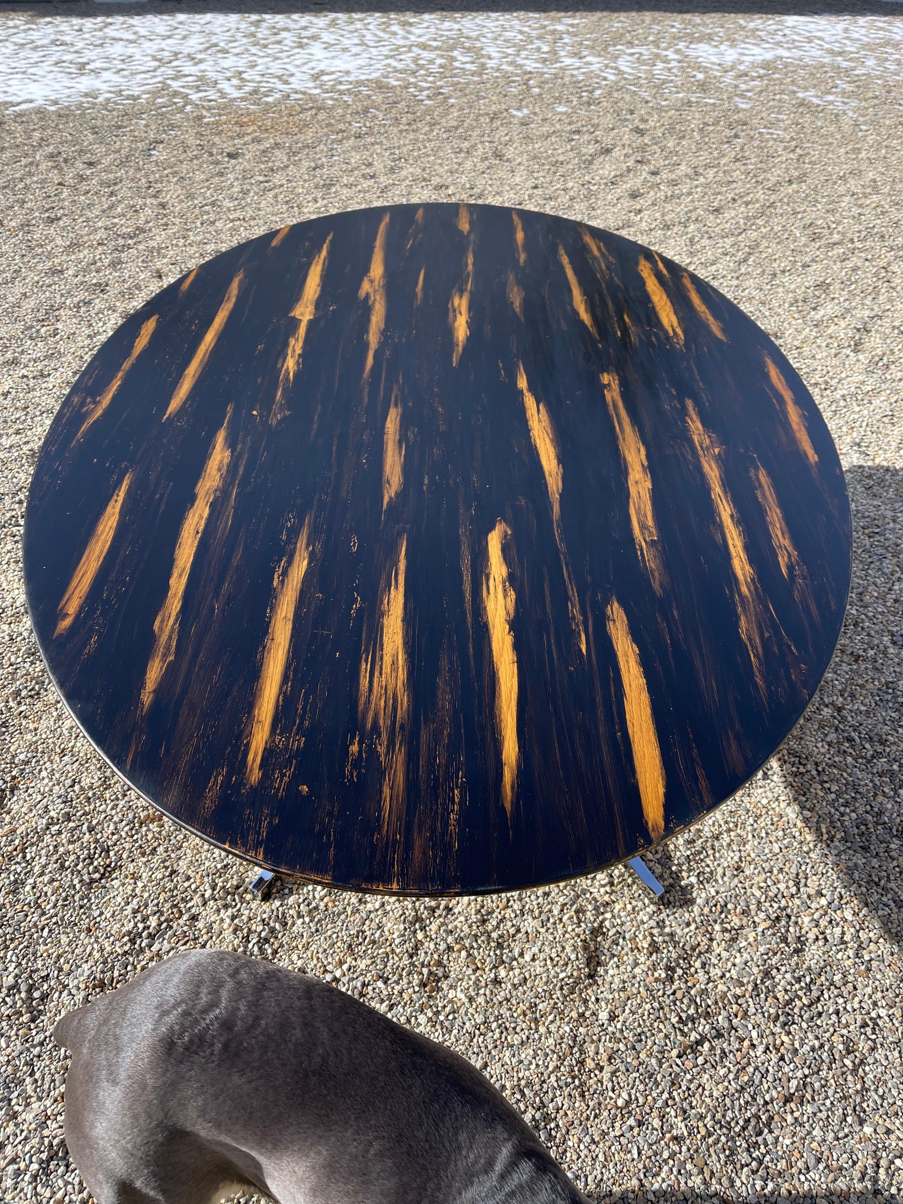 This Table was originally designed by Florence Knoll in 1961. 
The top is veneered in book matched oak and hand painted by Alexander Westerhoff inspired by an African Shield. The finish is a special method he used to achieve a dry charcoal look and