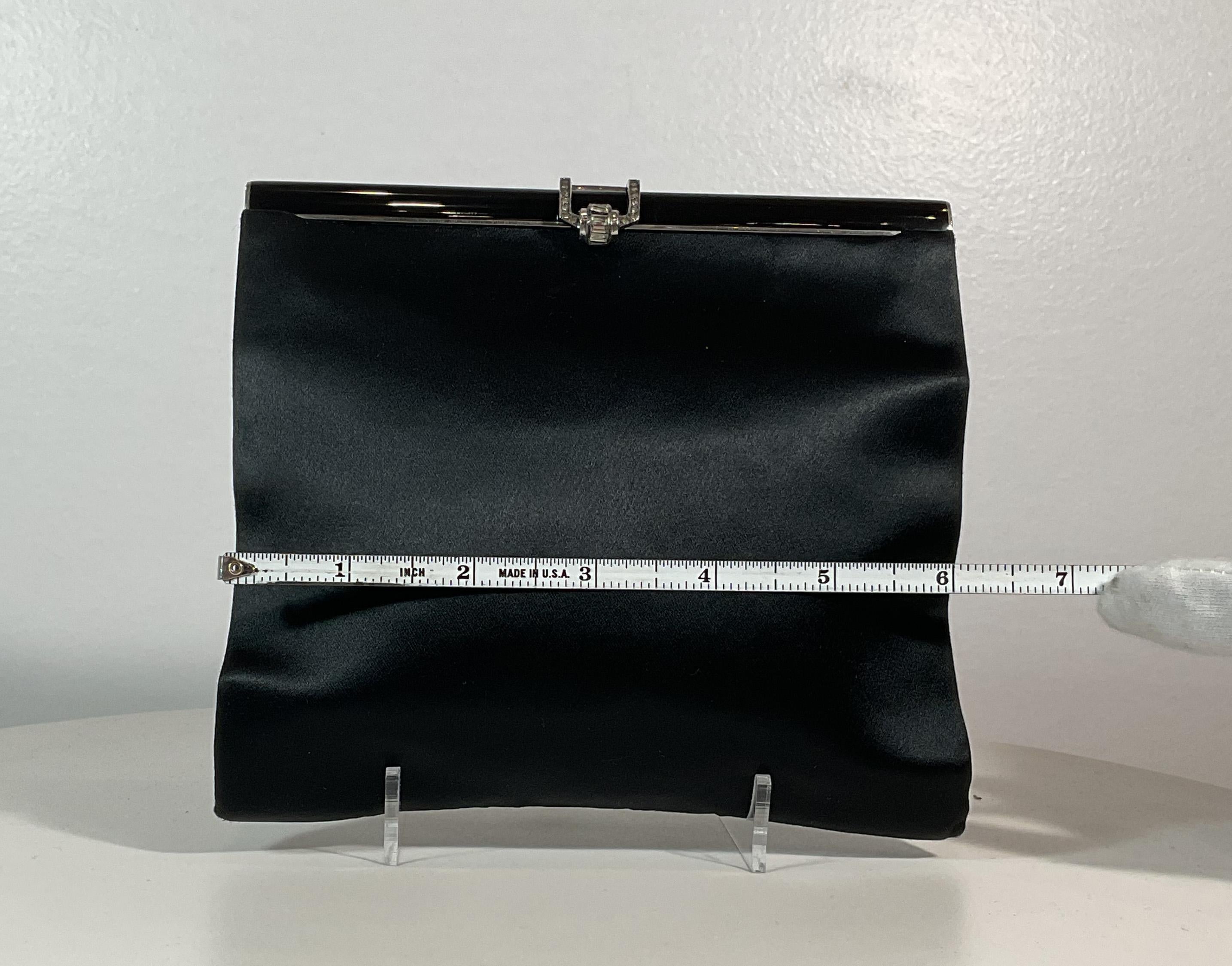 A La Reine Des Fées black satin evening clutch with rhinestone clasp. This evening clutch is in 'LIKE NEW' condition. There are no significant flaws or wear areas to consider with this lovely evening clutch. It had been very gently used and