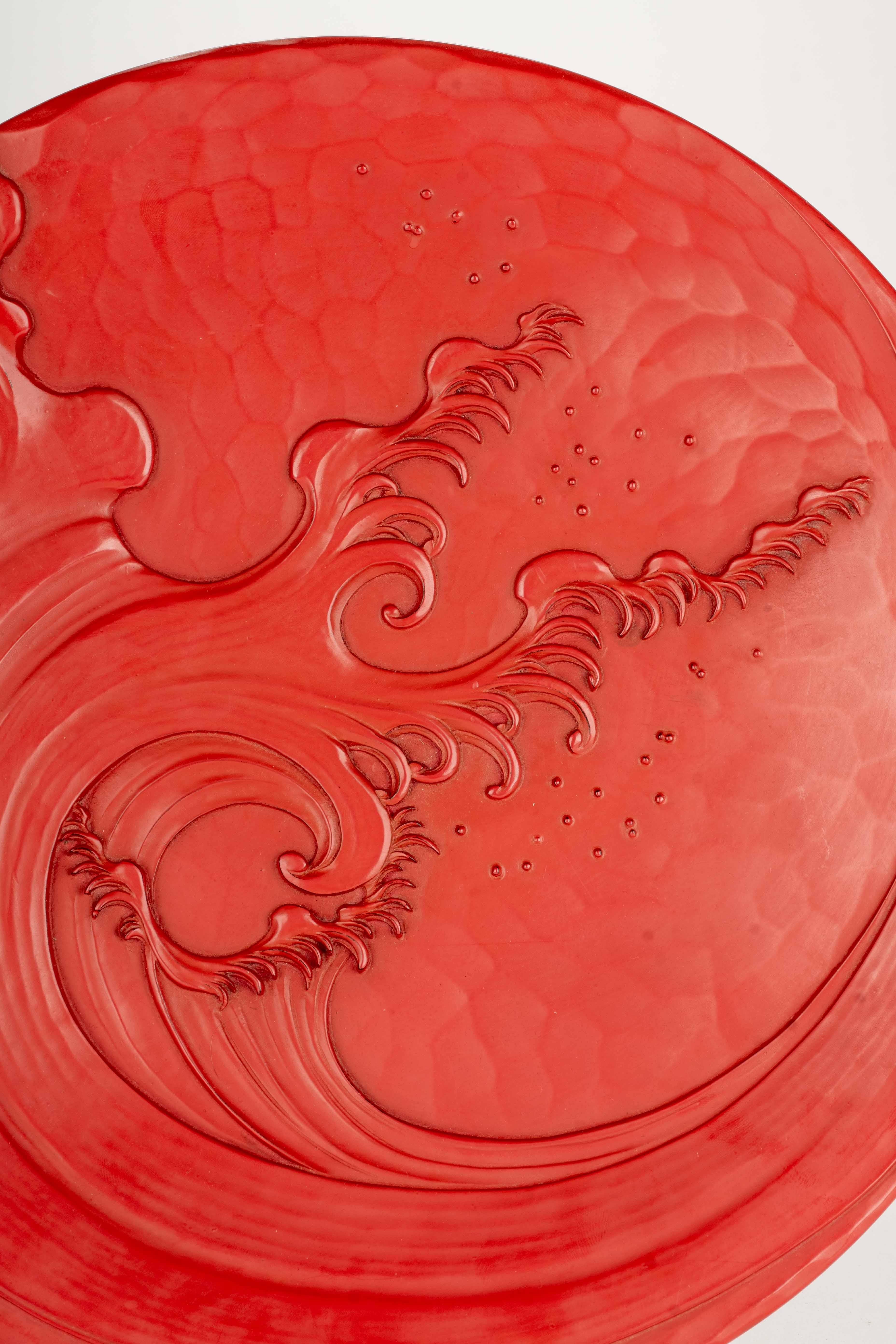 Japanese A lacquered wooden plate decorated in relief with a majestic wave