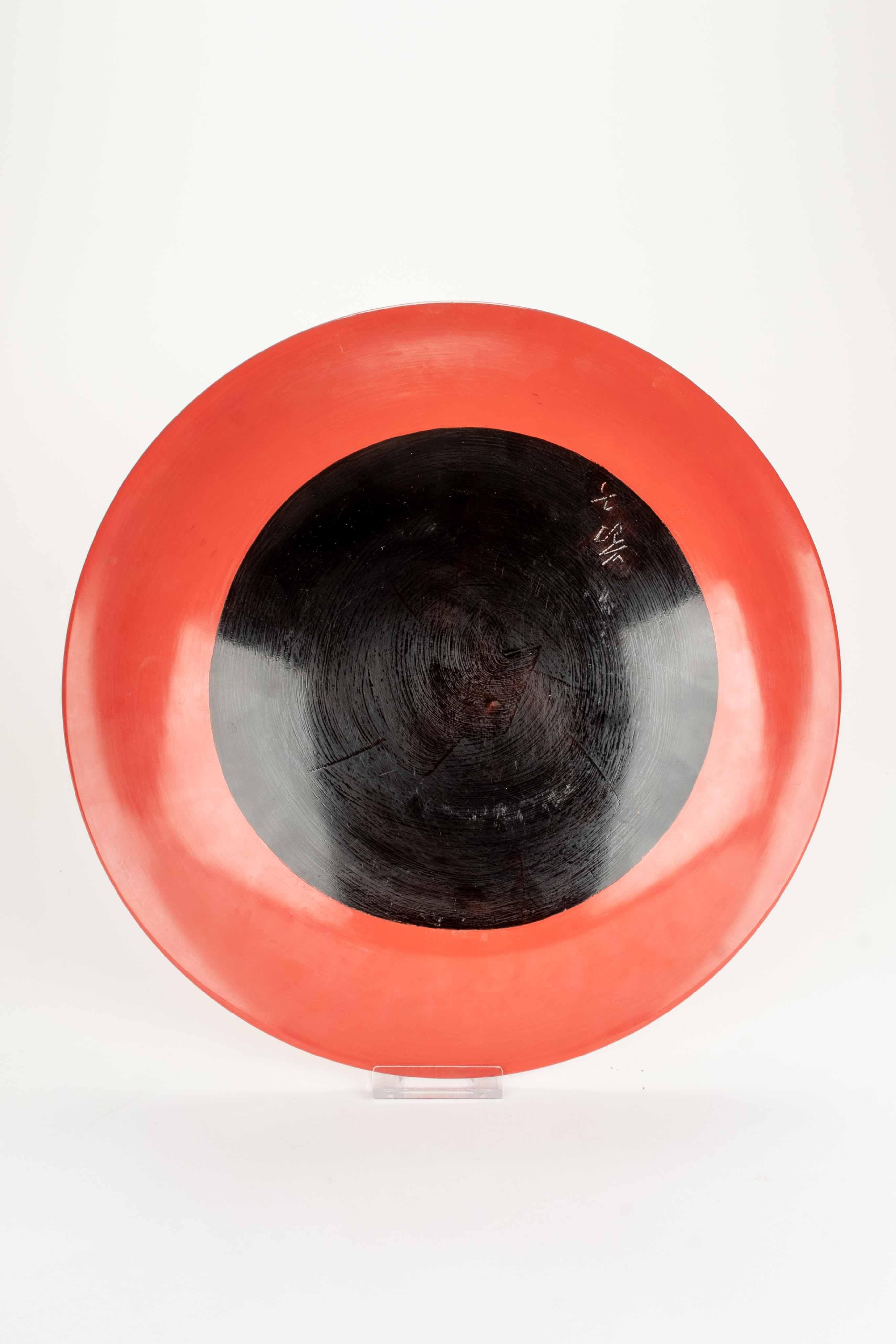 20th Century A lacquered wooden plate decorated in relief with a majestic wave