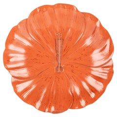 A lacquered wooden plate in the shape of a cherry blossom