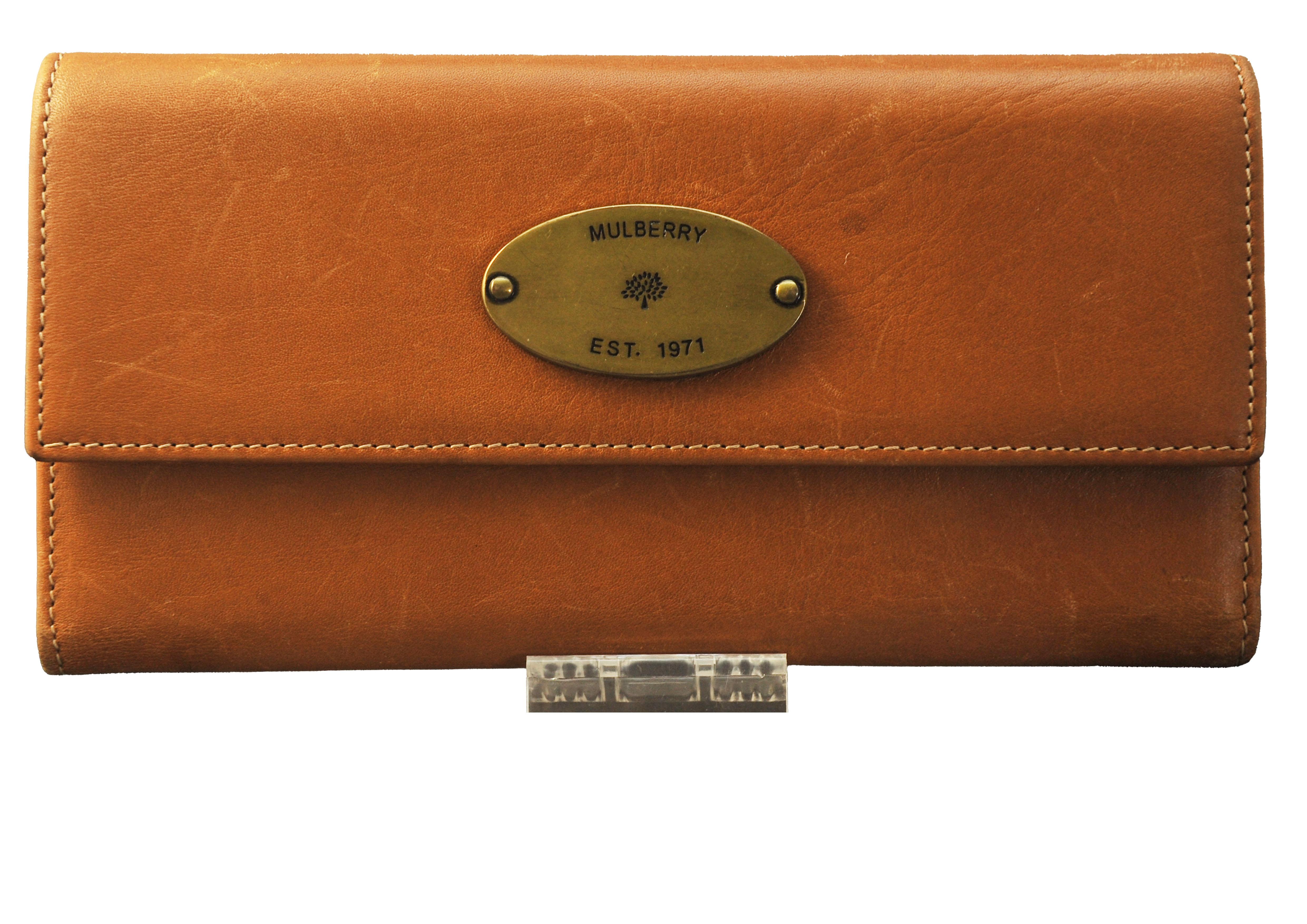 A Ladies Mulberry Tan Datwin Leather Wallet with Original Dust Cover & Grey Cardboard Gift Box.

The company was founded in 1971 by Roger Saul and his mother, Joan. In 1973, they opened a factory in Chilcompton, Somerset, England. The area was
