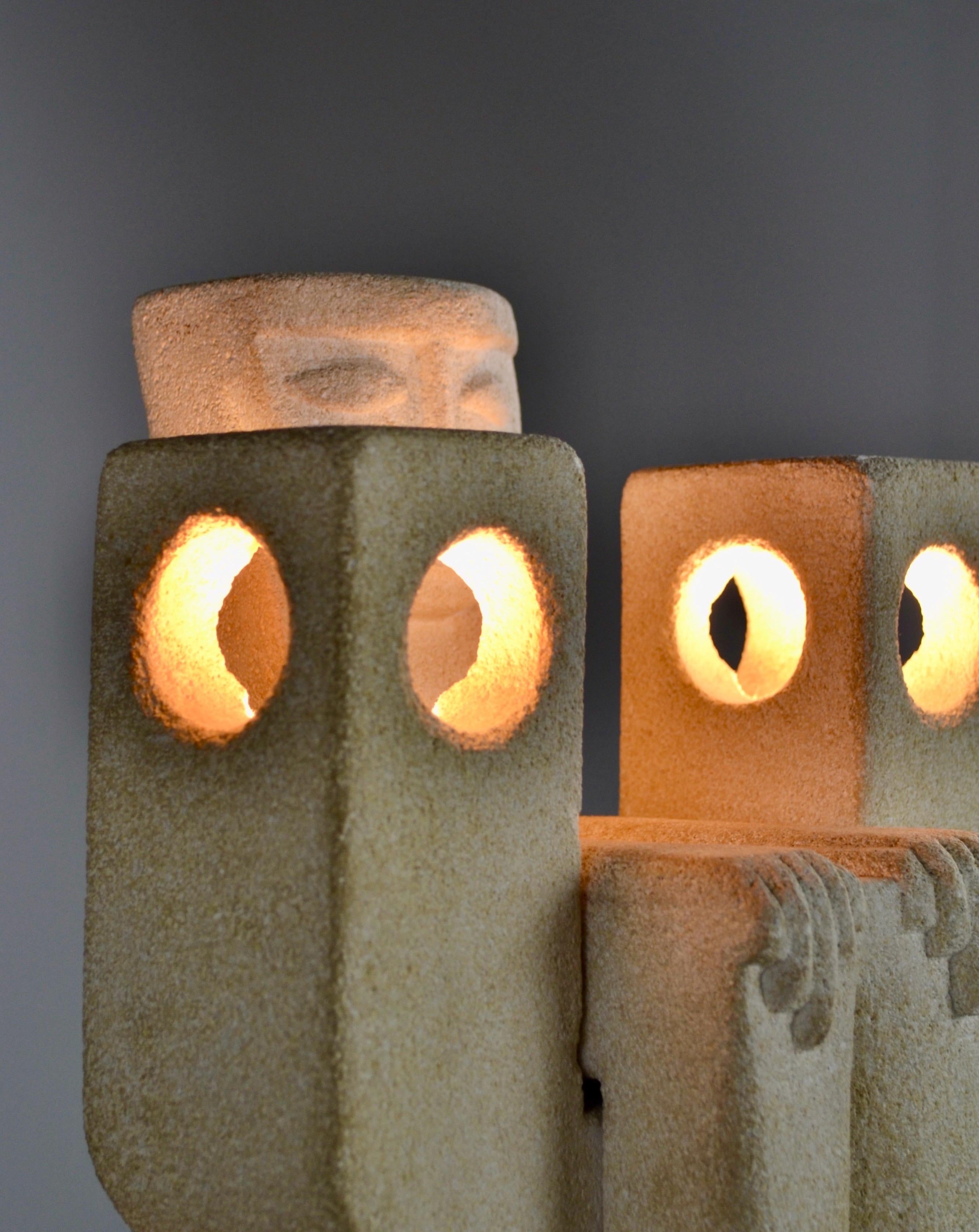 A stunning lamp crafted in limestone from the 1970s, signed Albert Tormos, renowned for his iconic sculptural lighting pieces. This rare and sought-after work is composed of two parts: a seated figure with clean, minimalist lines resting on a base