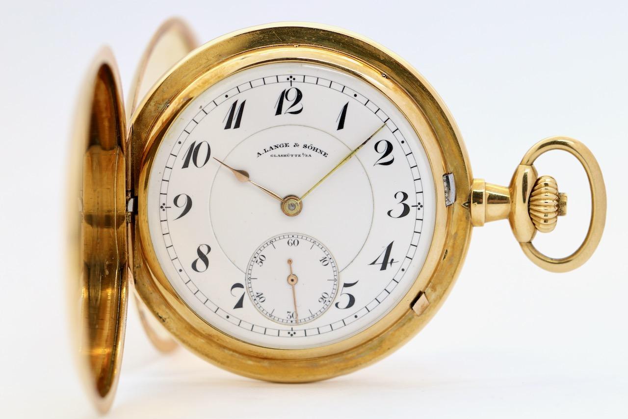 This elegant A. Lange & Söhne triple-hinged savonette pocket watch is a refined example of Glashütte’s finest watchmaking traditions. Crafted from solid 18K yellow gold, the case is designed in the classic savonette (hunter-case) style, offering a