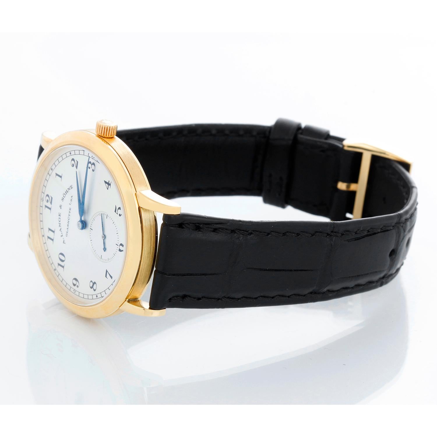 A. Lange & Sohne 1815 Men's Yellow Gold Watch 206.032 - Manual winding. Yellow Gold case with exhibition back (36mm diameter). Silver dial with Arabic numerals; sub-seconds dial. Black croc strap band with yellow gold Lange buckle. Pre-owned with